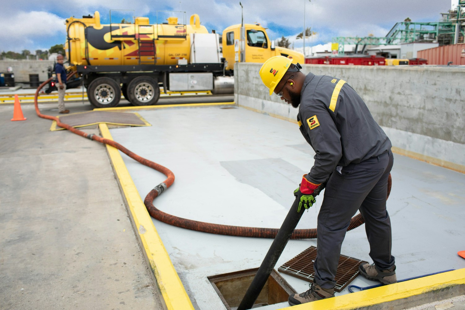 Employee using equipment to take used oil from a customer