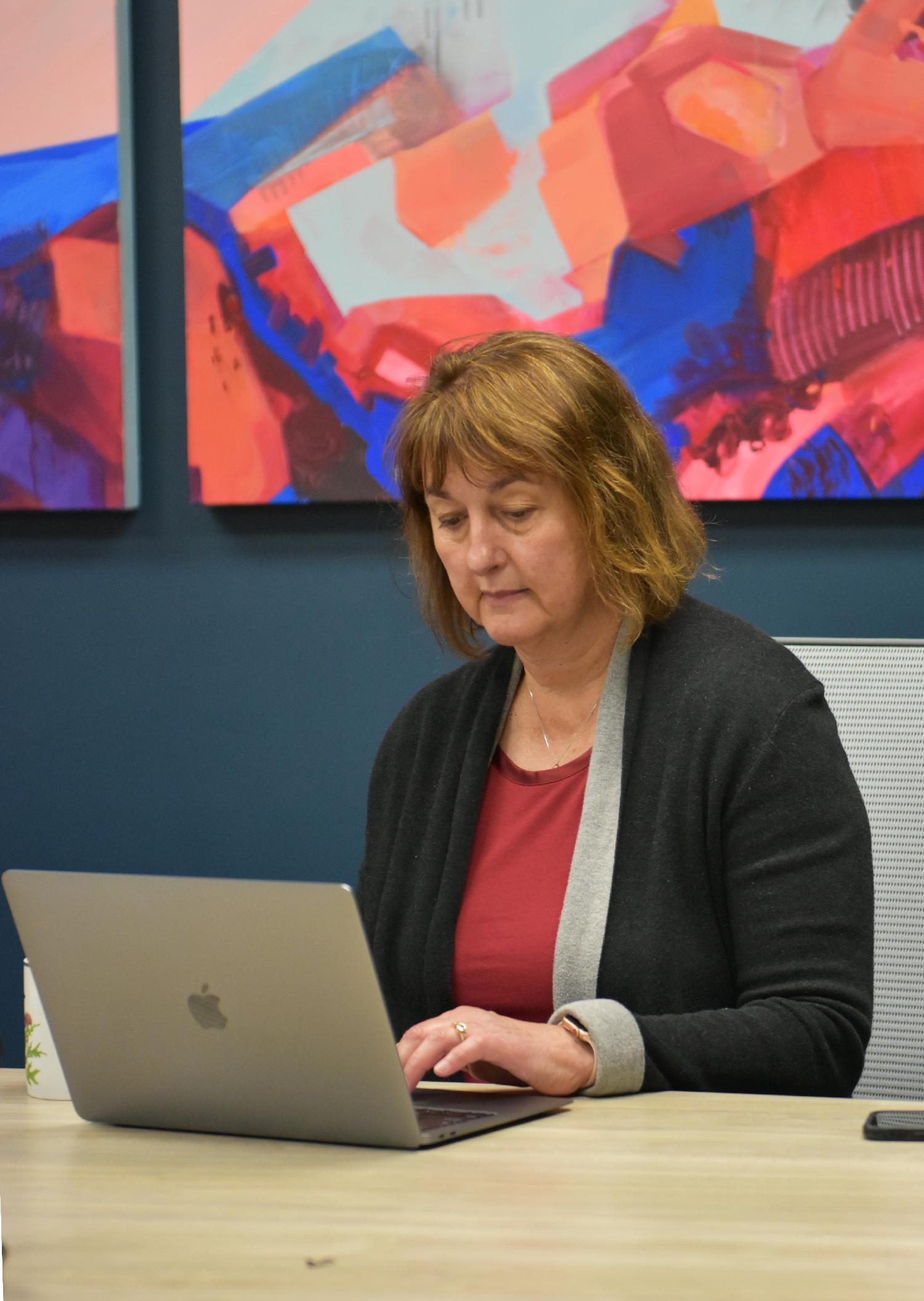 Beth Kelly, President and Visionary of HR Collaborative working in Coral Reef room - named for collaborations in nature.