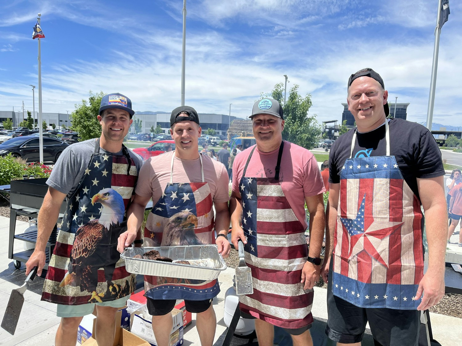 Awardco C-Suite members working the grills at the summer BBQ