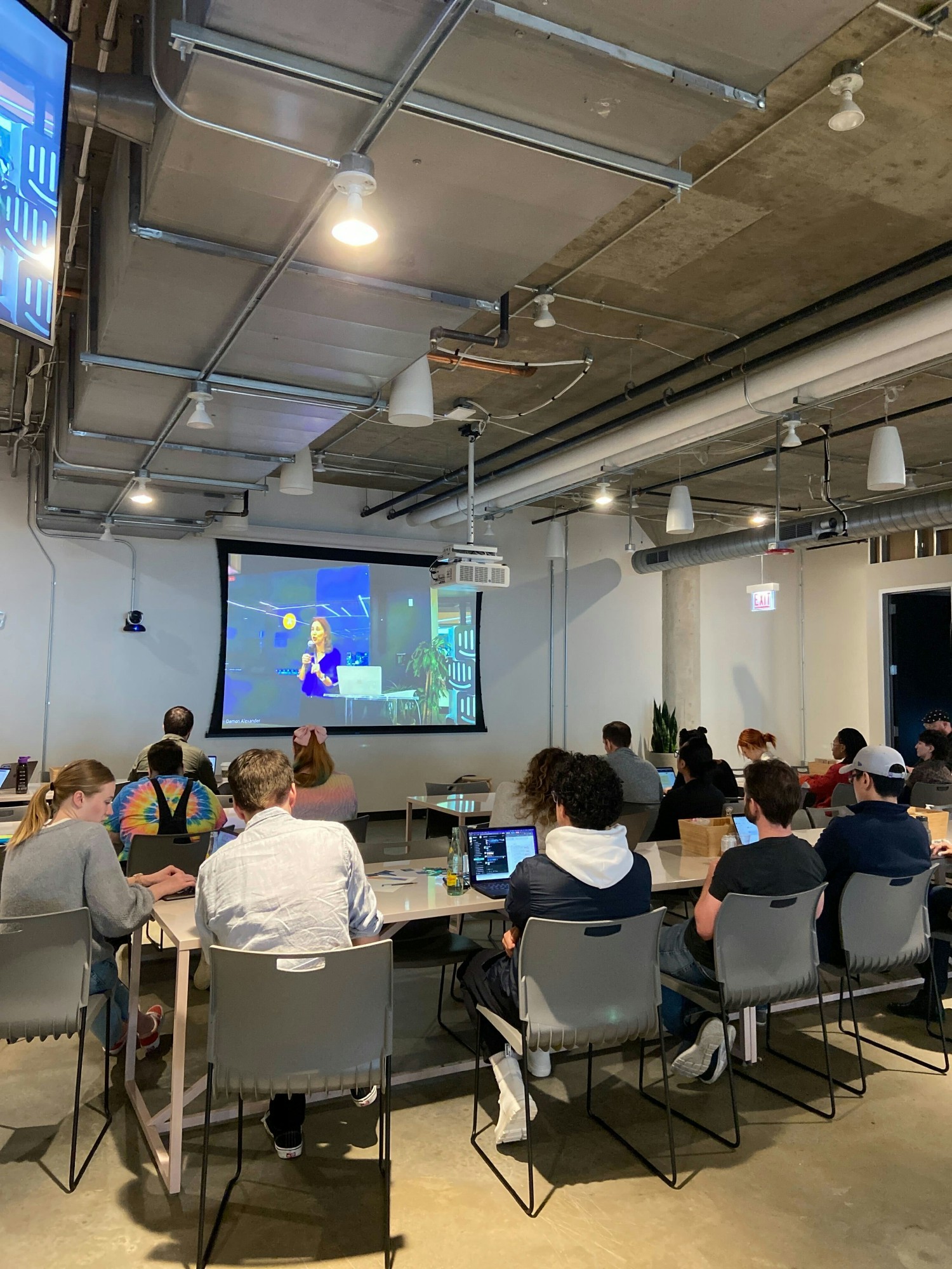 Intercom employees in the Chicago office gather to watch the company All-hands meeting.