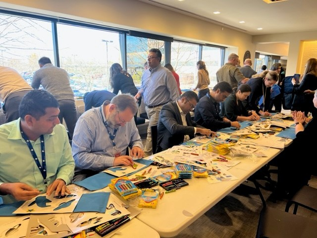 Otsuka-people assembling Sweet Case Duffle bags for youth in foster care.