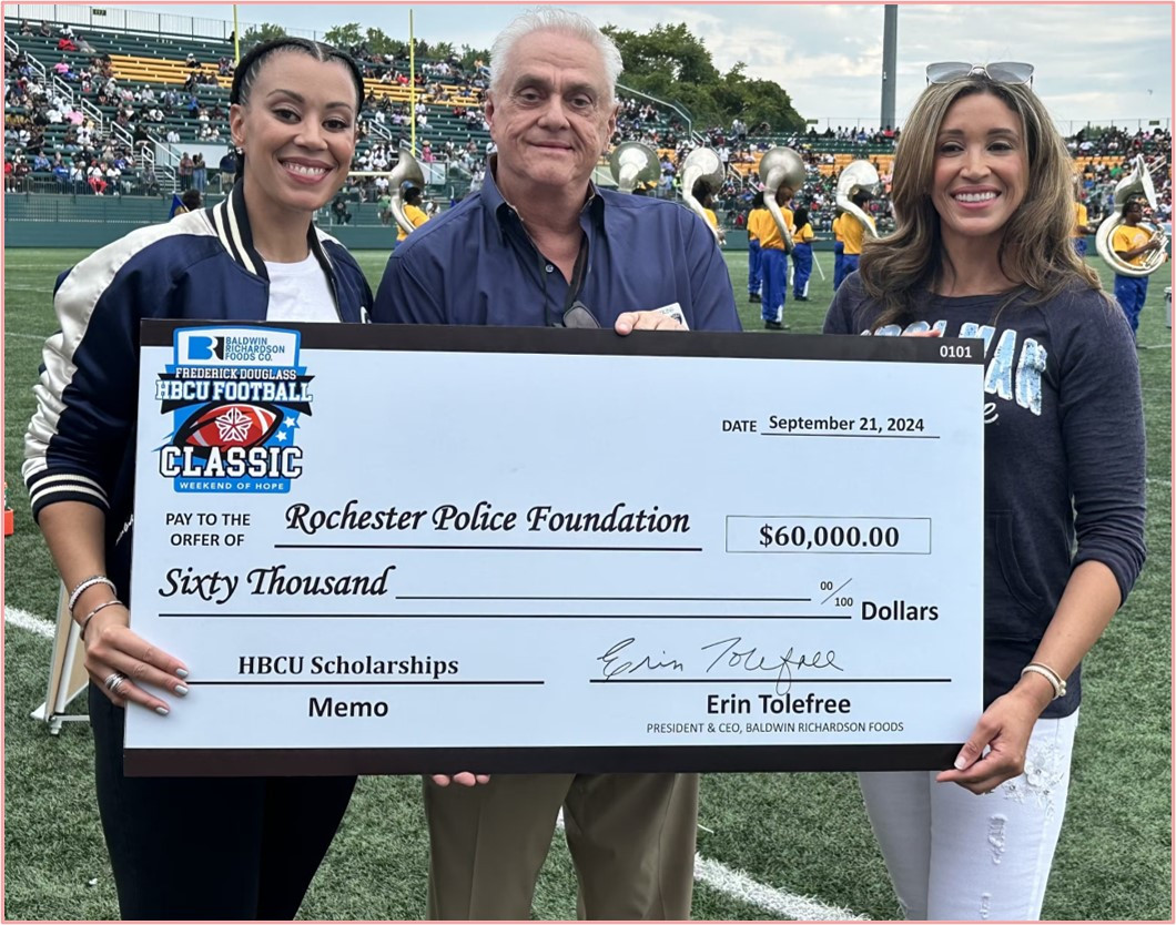 Cara Hughes & Erin Tolefree presenting funding for HBCU Scholarships at the Frederick Douglas Weekend of Hope HBCU game.