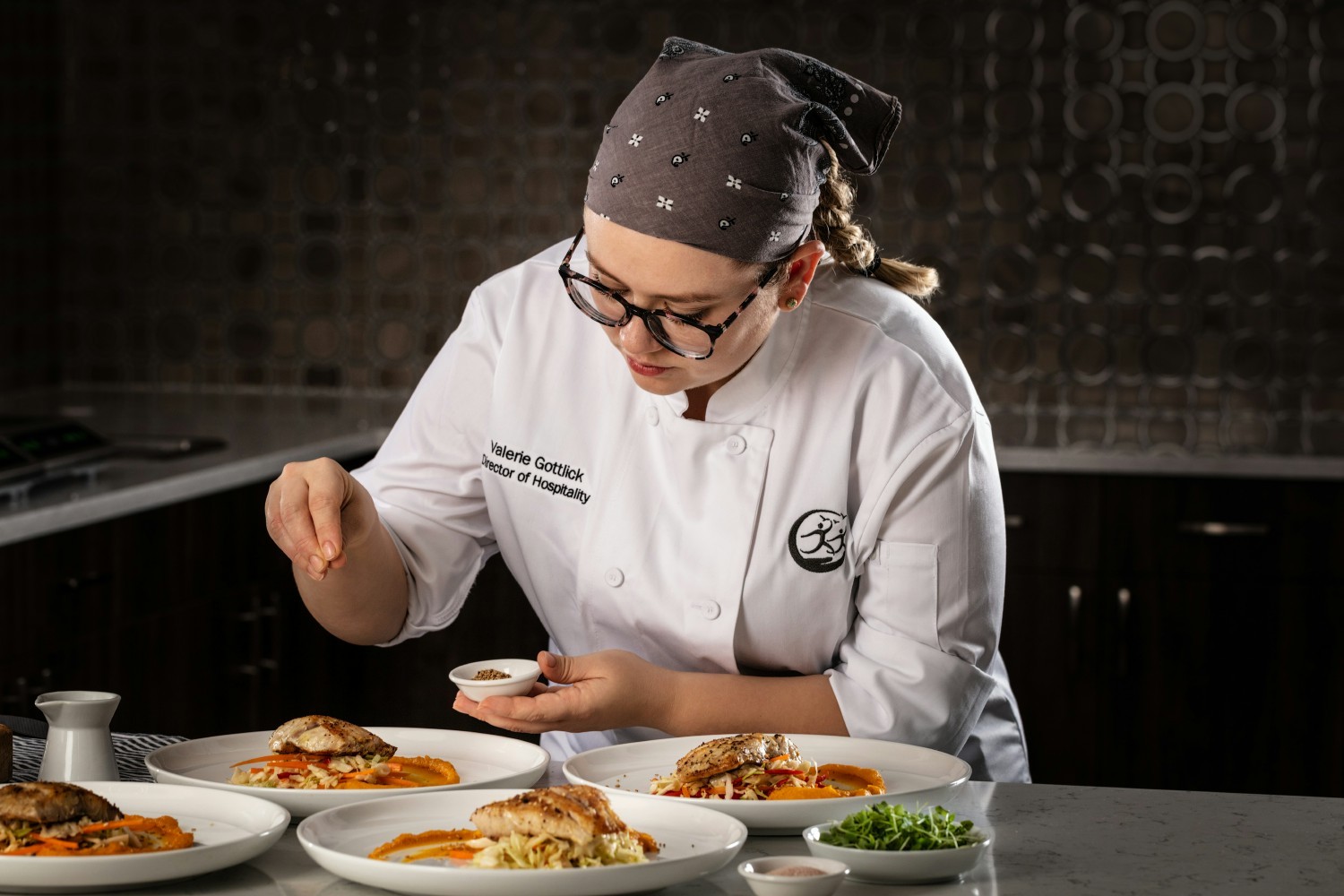 Chef Valerie Gottlick featured in the Chefs Studio, plating one of her signature dishes.