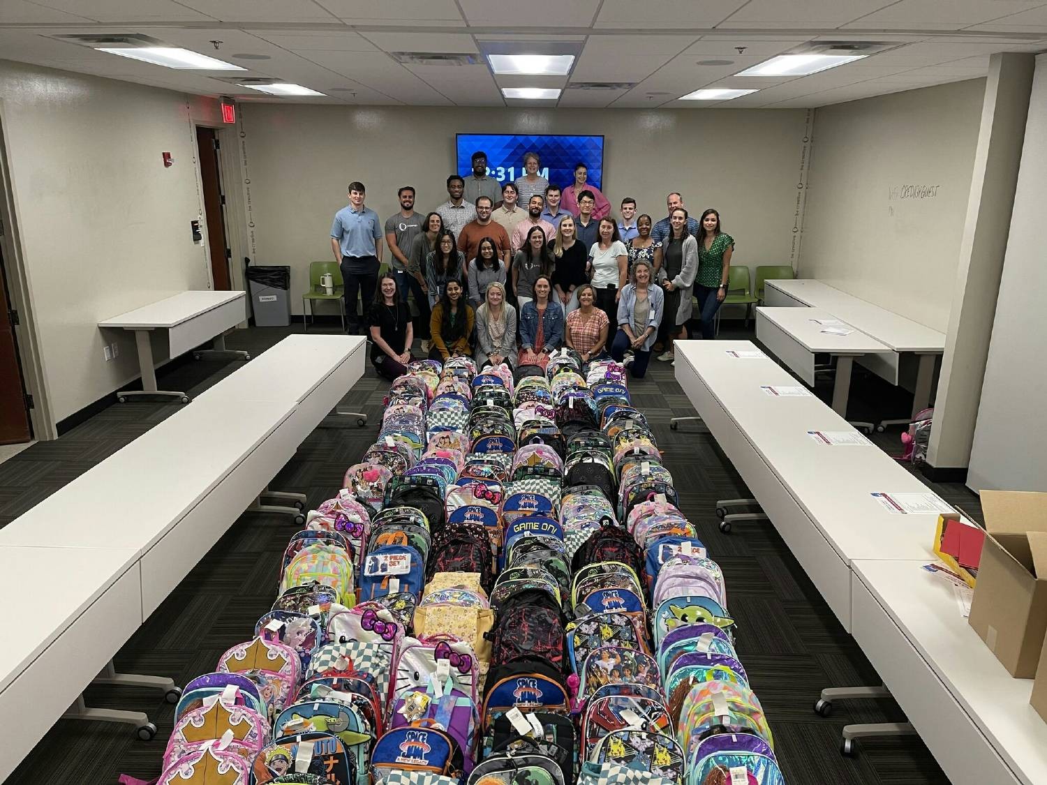 Employees packed 200 backpacks full of supplies for North Fulton Community Charities to help kids start the school year.