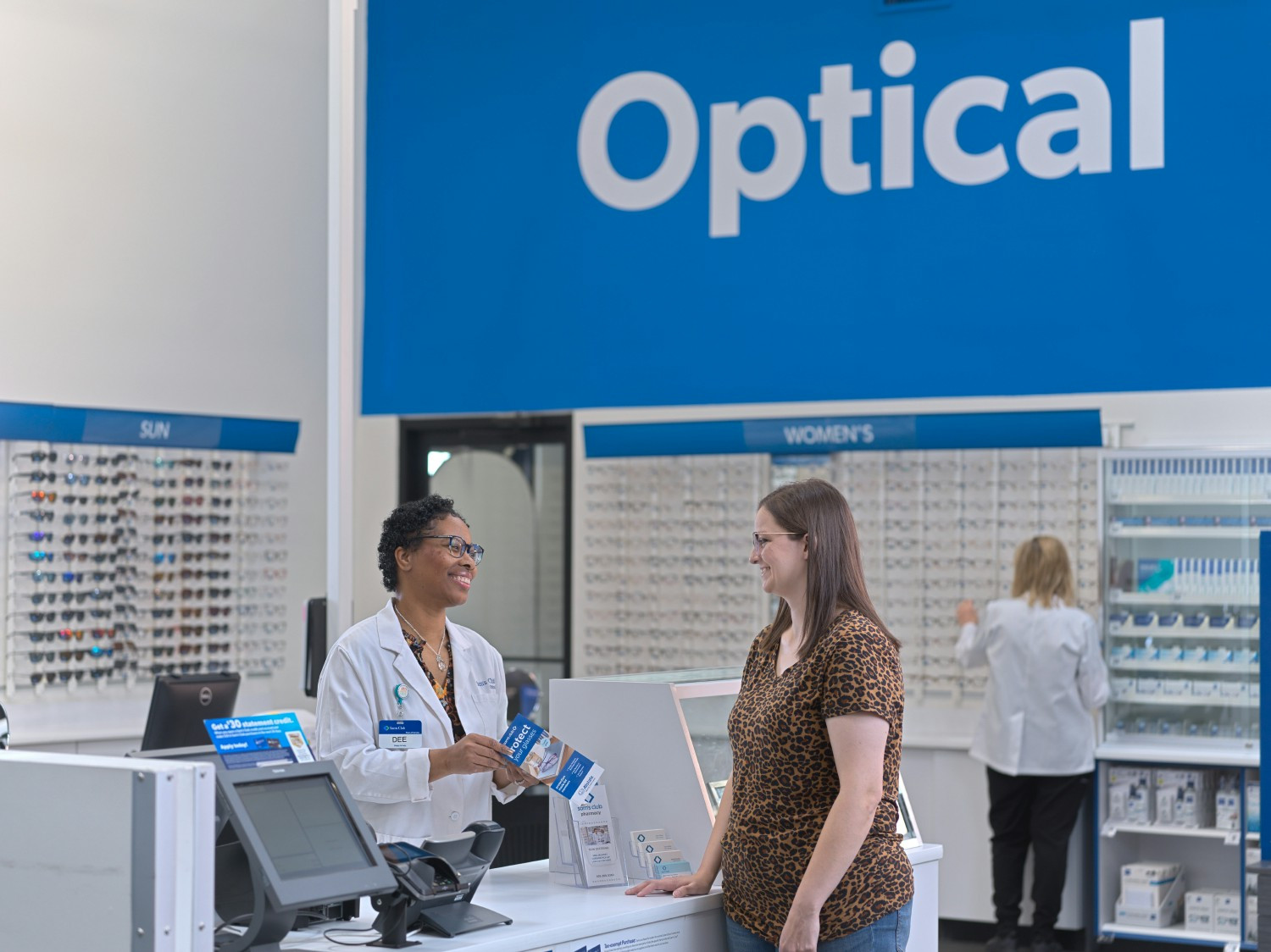 Optical associate helping a member.