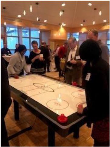 Glory employees enjoy an Air Hockey Competition during our Annual Holiday Party