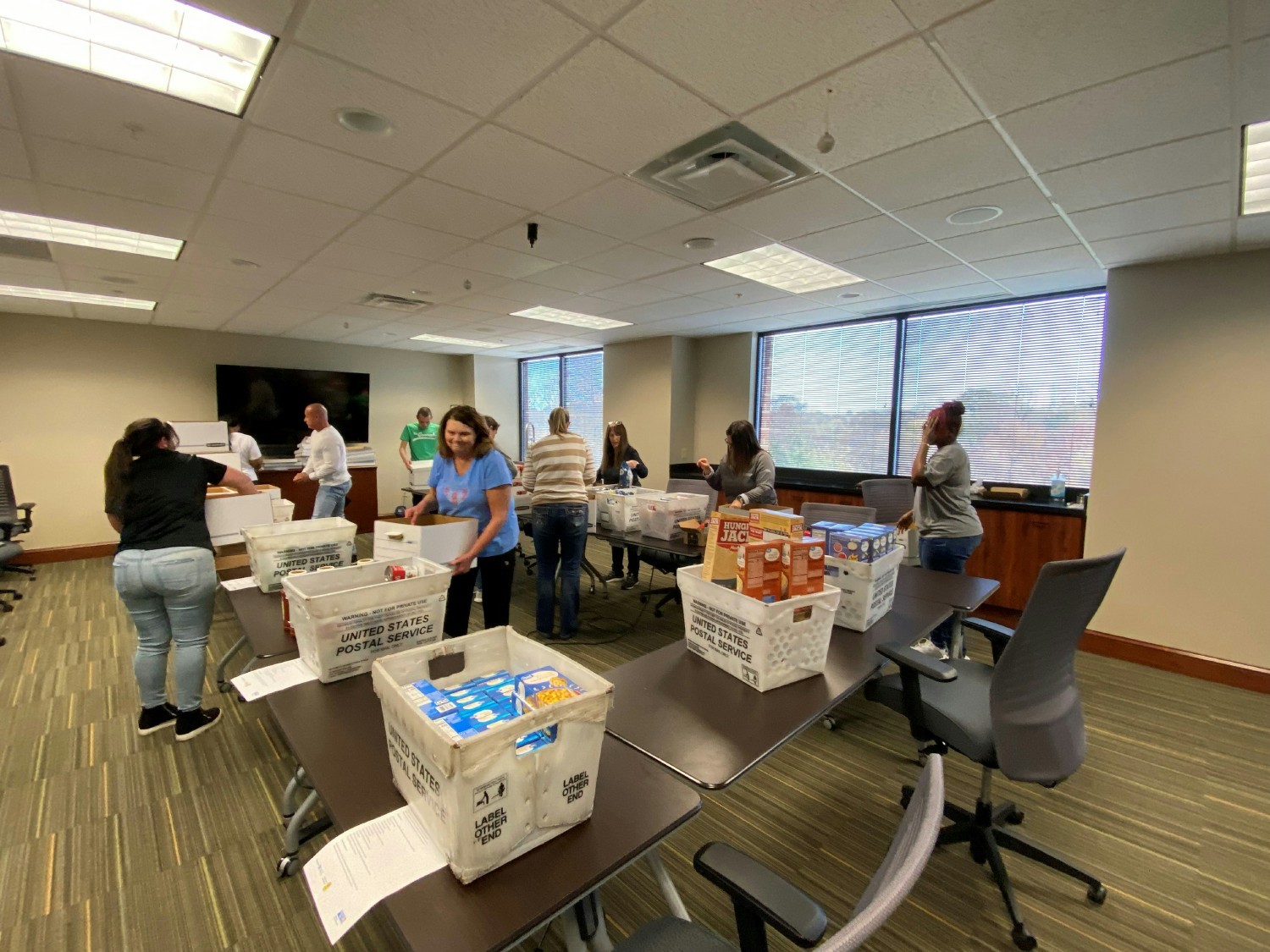 Employees get together to sort food used for holiday meals for families.