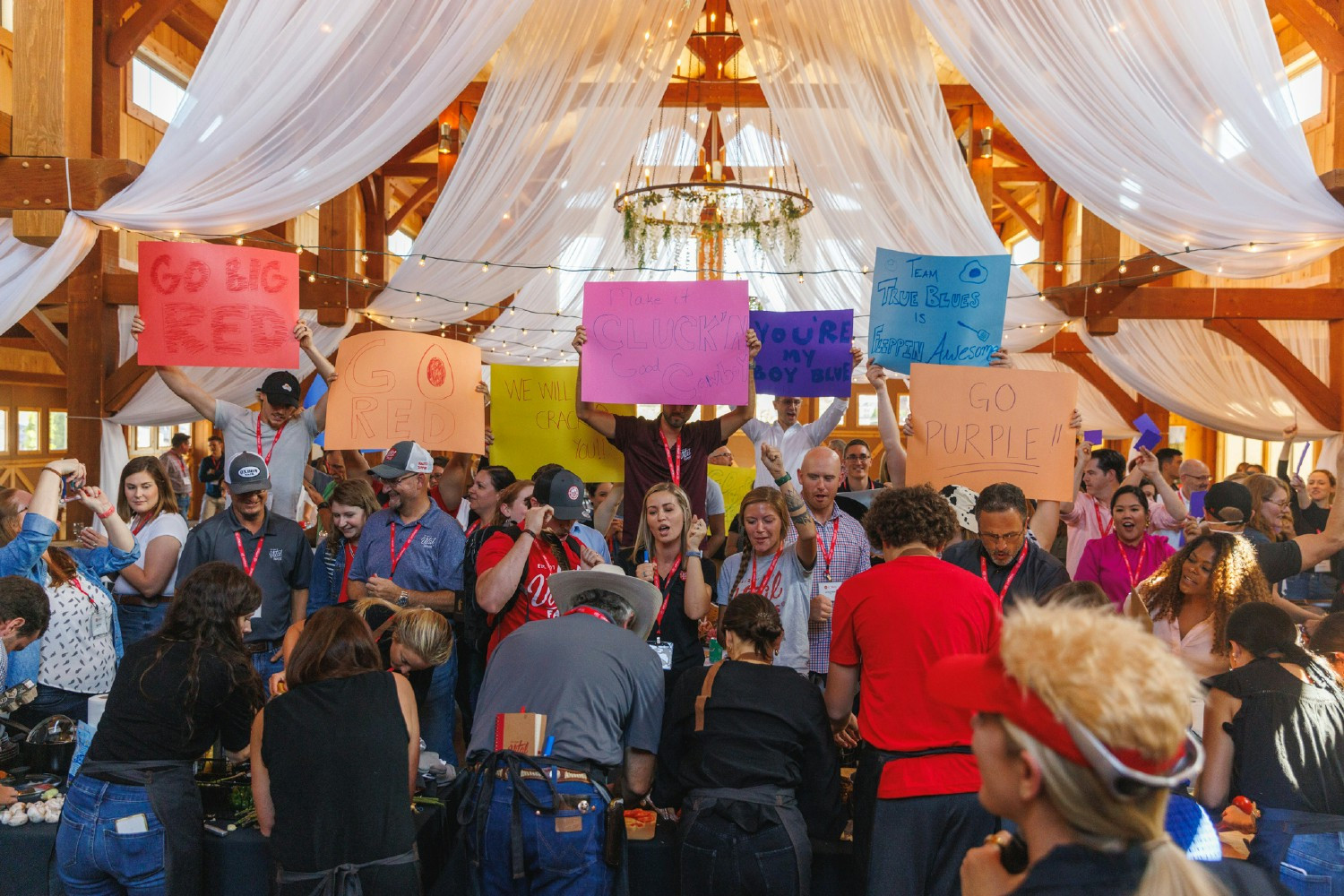 Vital Farms crewmembers cheer on their teams during cooking competition at all company retreat