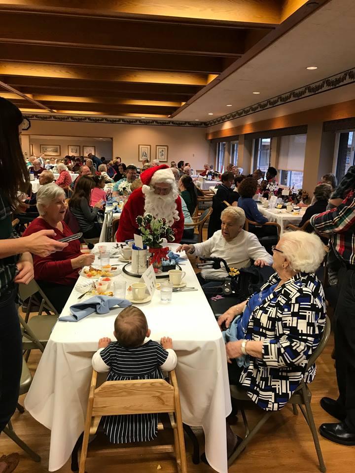 Christmas Dinner: Residents being served at one of Luther Manor's many celebrations!