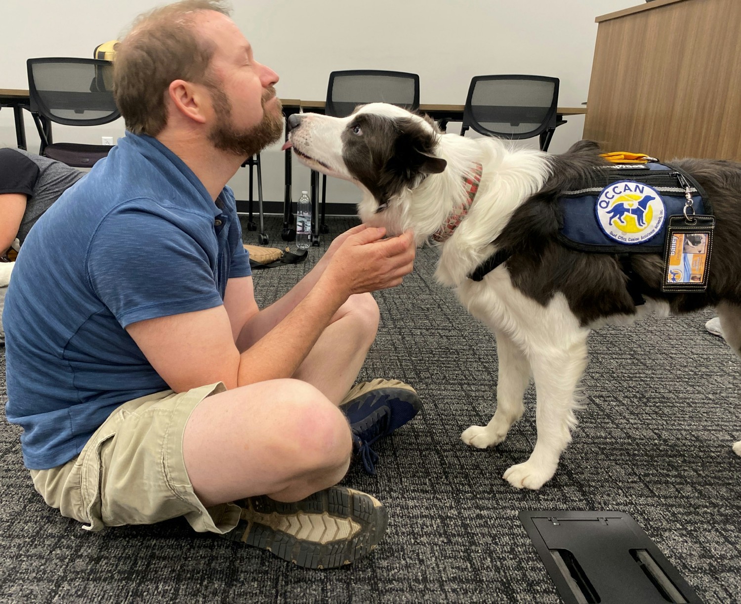 Vibrant Team Members take a break with therapy dogs from the Quad Cities Canine Assistance Network (QCAN).