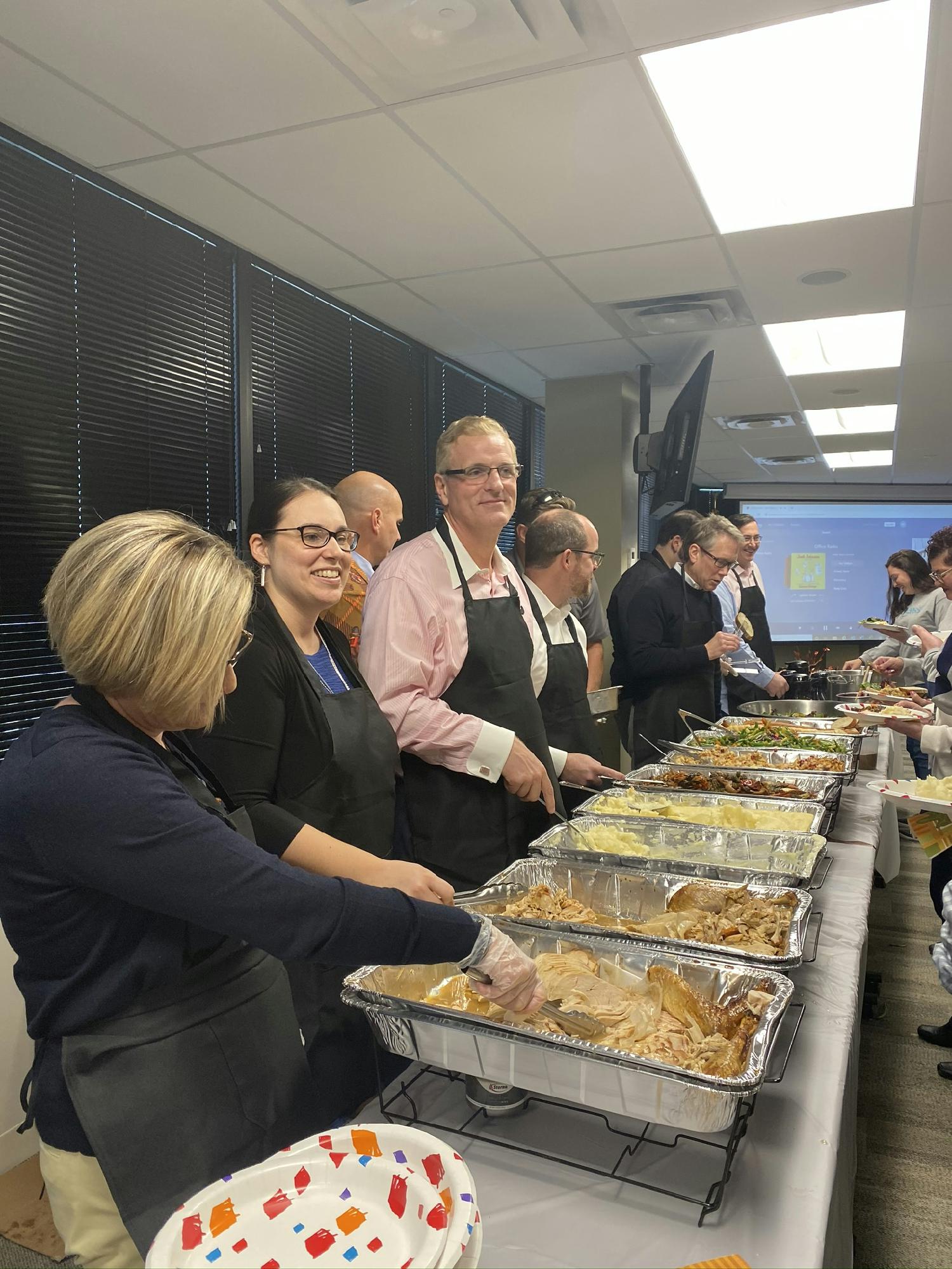 Our executive team serves employees a Fall Feast.