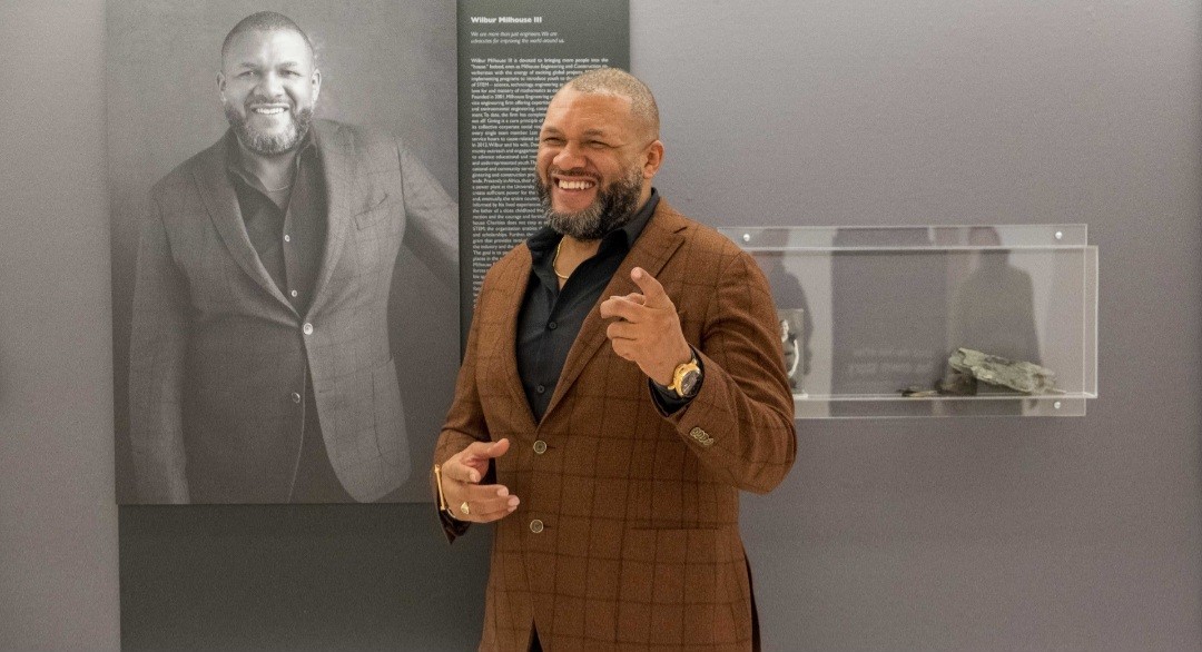 Milhouse Chairman/CEO Wilbur Milhouse III in front of his feature at the Chicago Cultural Center.