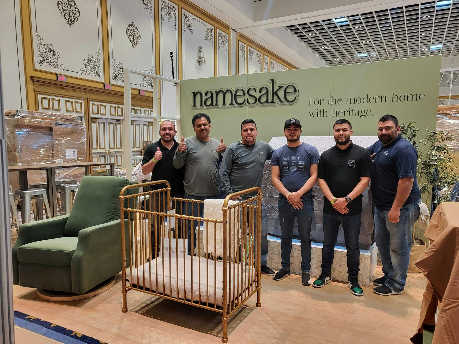 Warehouse staff strikes a triumphant pose after another successful set up at ABC Kids Expo 2023.