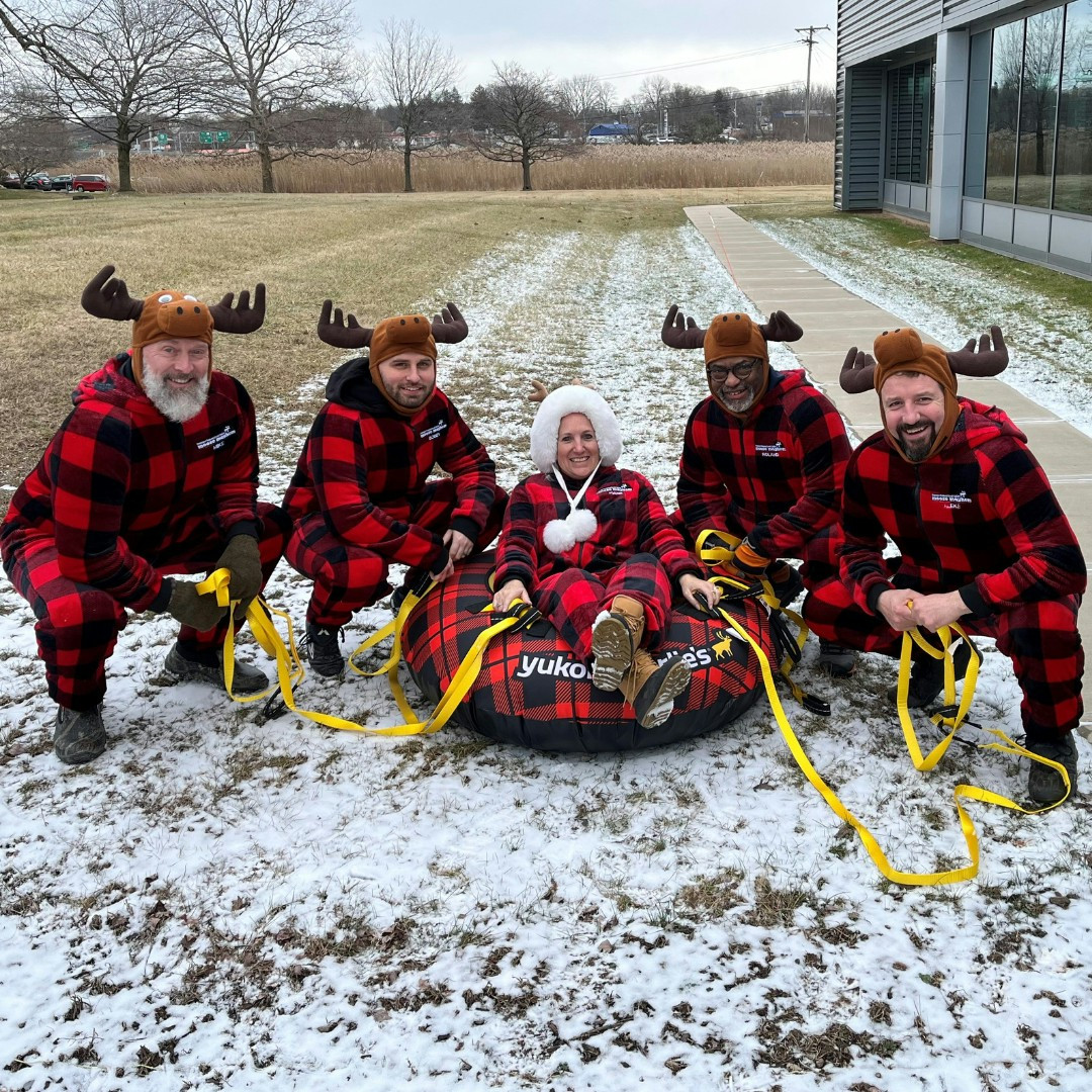 Empower FCU team members participating in The Syracuse Inner Harbor human dogsled race at Winterfest. 