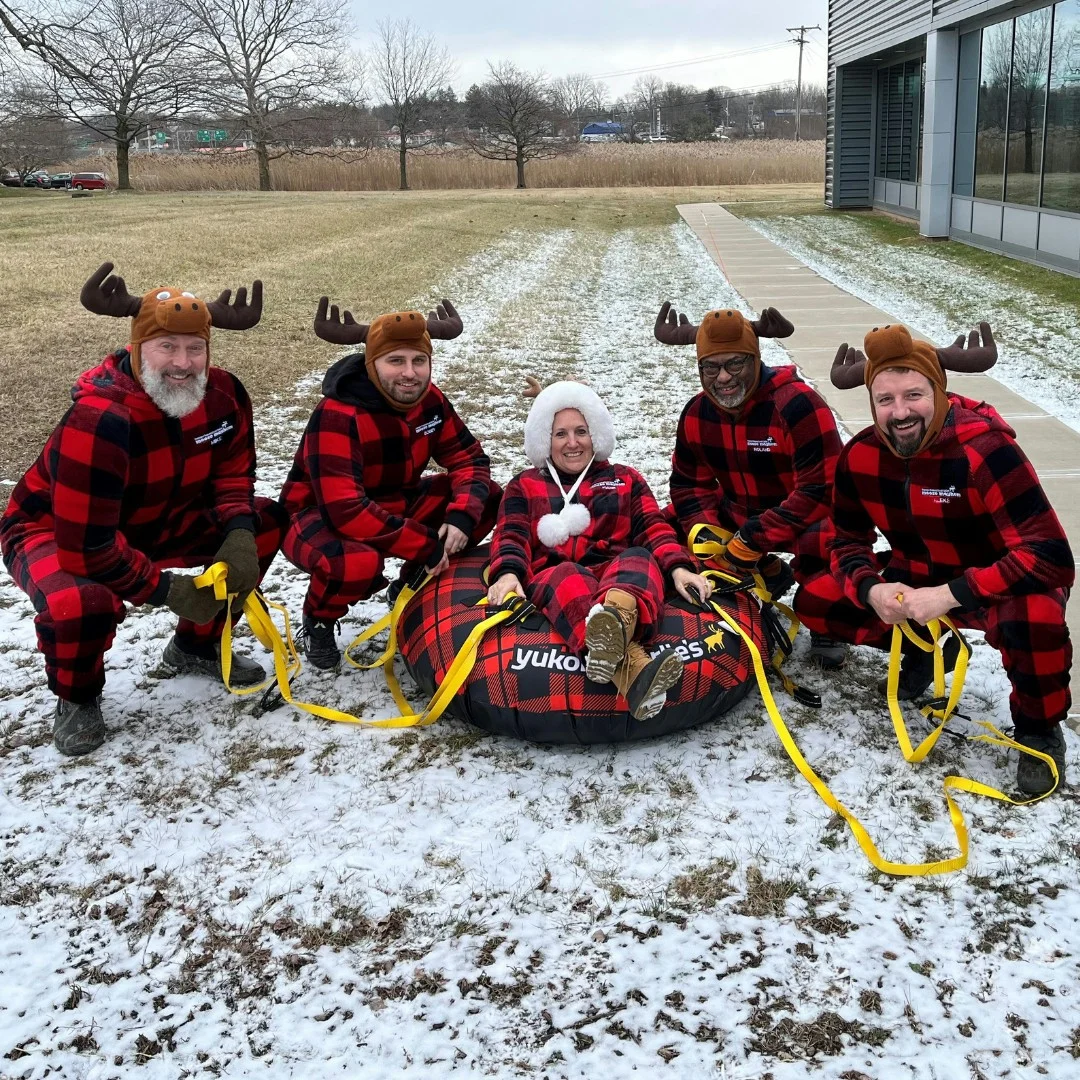 Empower FCU team members participating in The Syracuse Inner Harbor human dogsled race at Winterfest. 