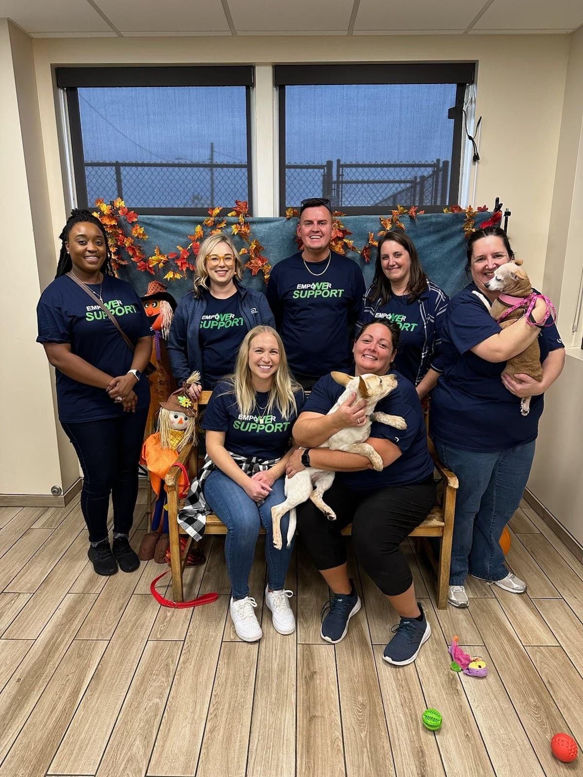 Team members dedicating volunteer hours to play with and care for adoptable dogs at Helping Hounds Dog Rescue.