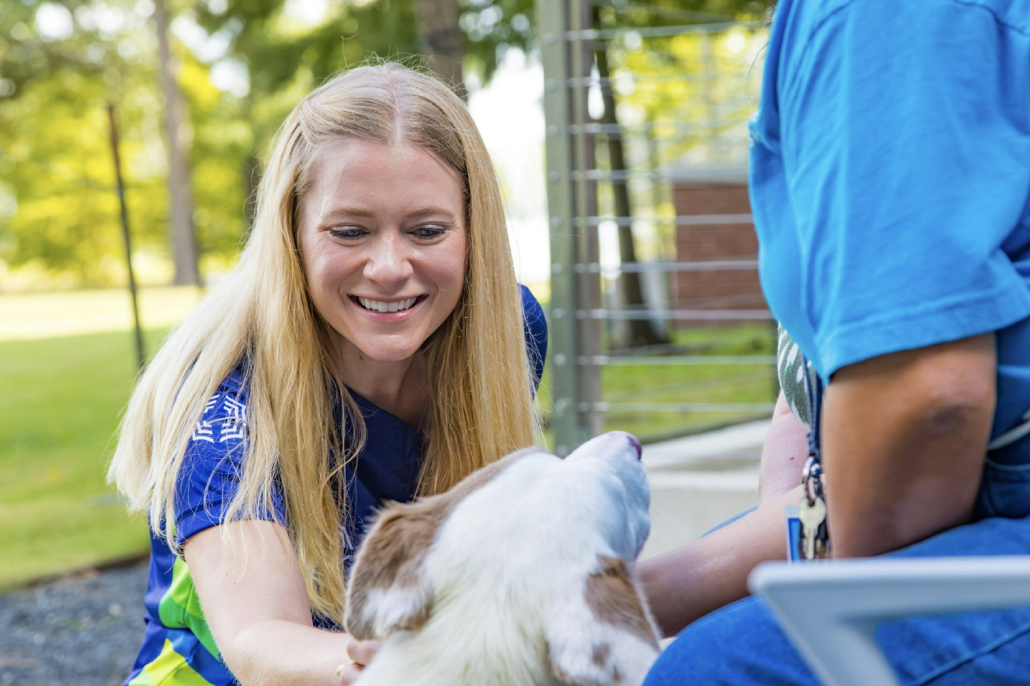 Insperity Wellbeing Manager Joy Awe spends time with a puppy at last year's wellness expo.