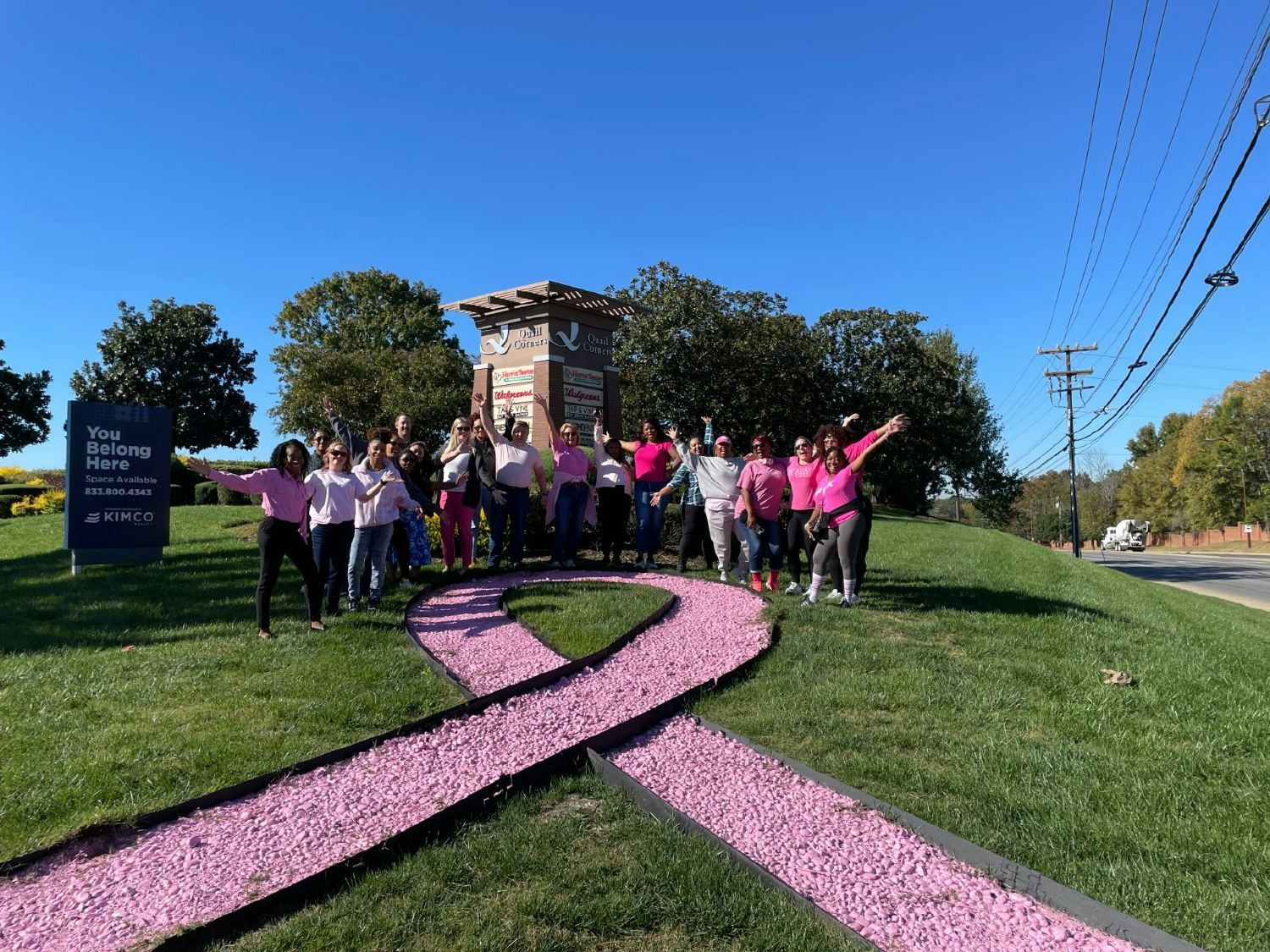 Charlotte associates wore pink and gathered in front of a Kimco center to support Breast Cancer Awareness Month.