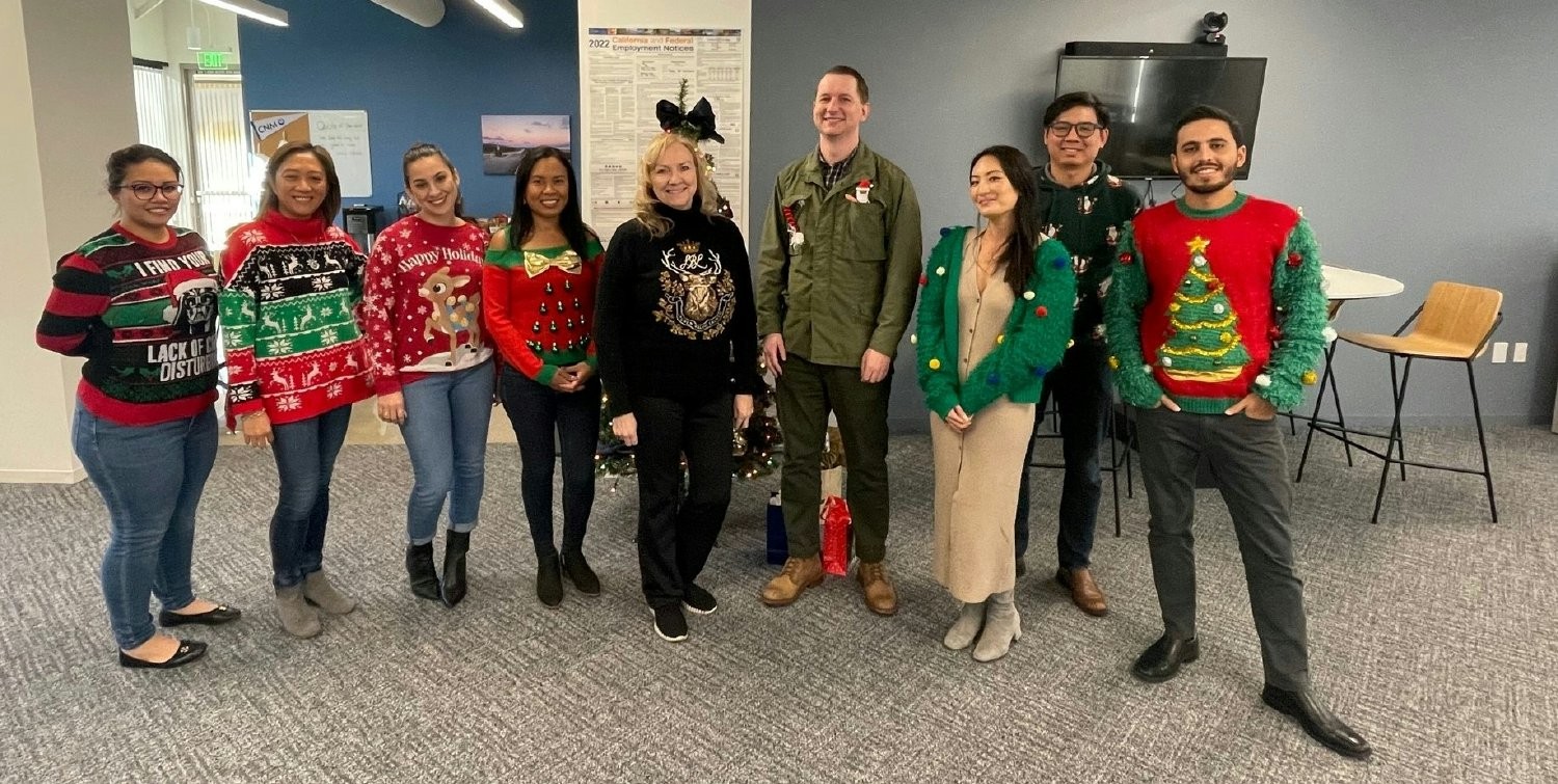 CNM's Orange County professionals looking festive while getting ready for the holidays with an ugly sweater contest 
