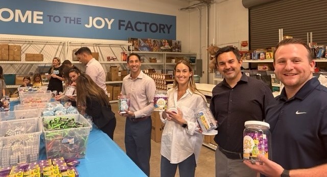 Professionals assembling JoyJars for kids with cancer at our most recent CNM Gives Back Event with the NEGU Foundation 