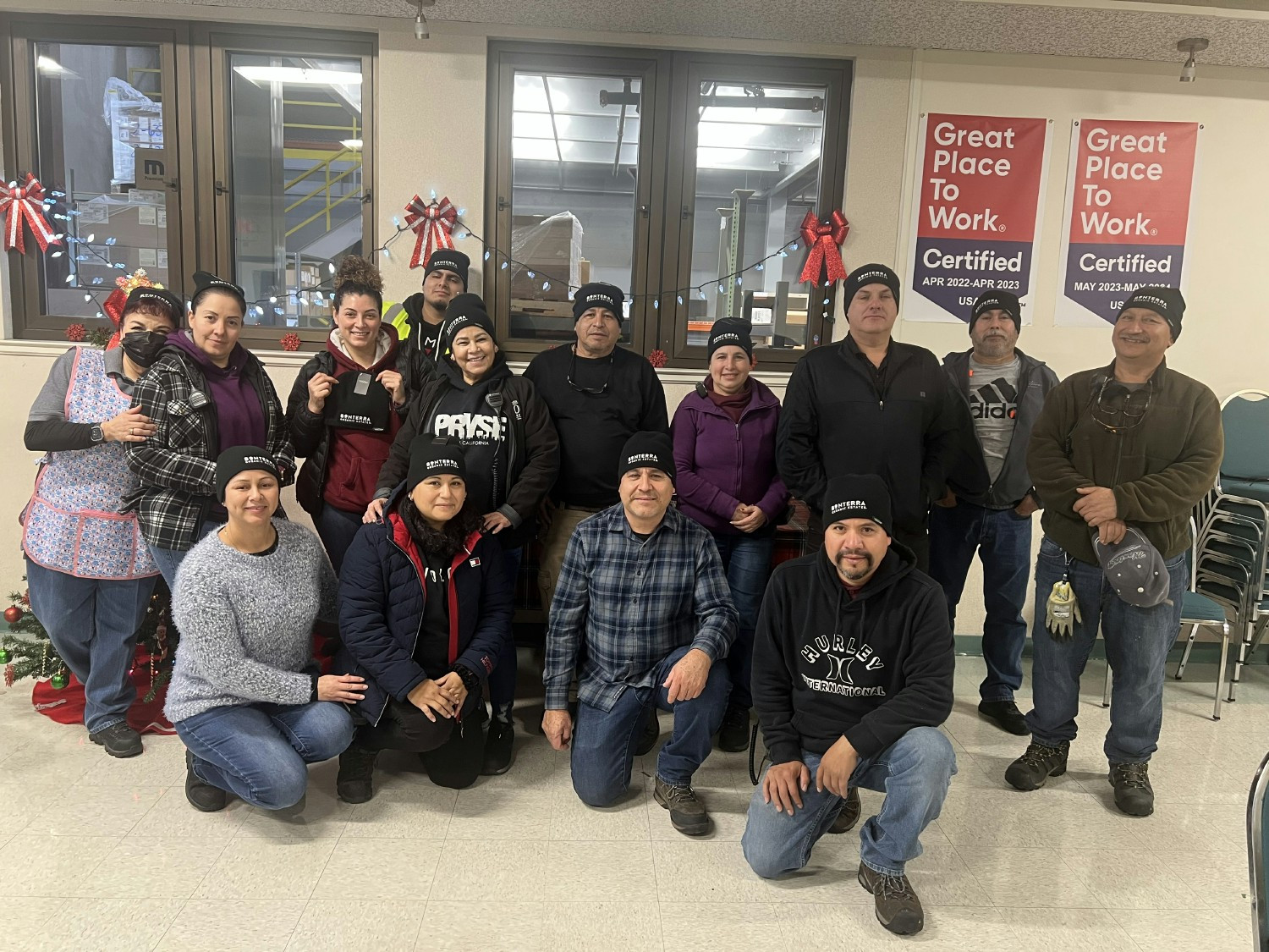 The bottling team shows off their new branded beanies.