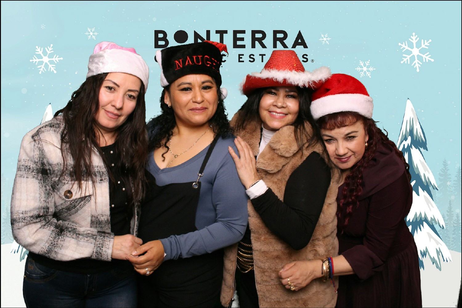 Employees have fun in the photo booth at Bonterras annual holiday party.