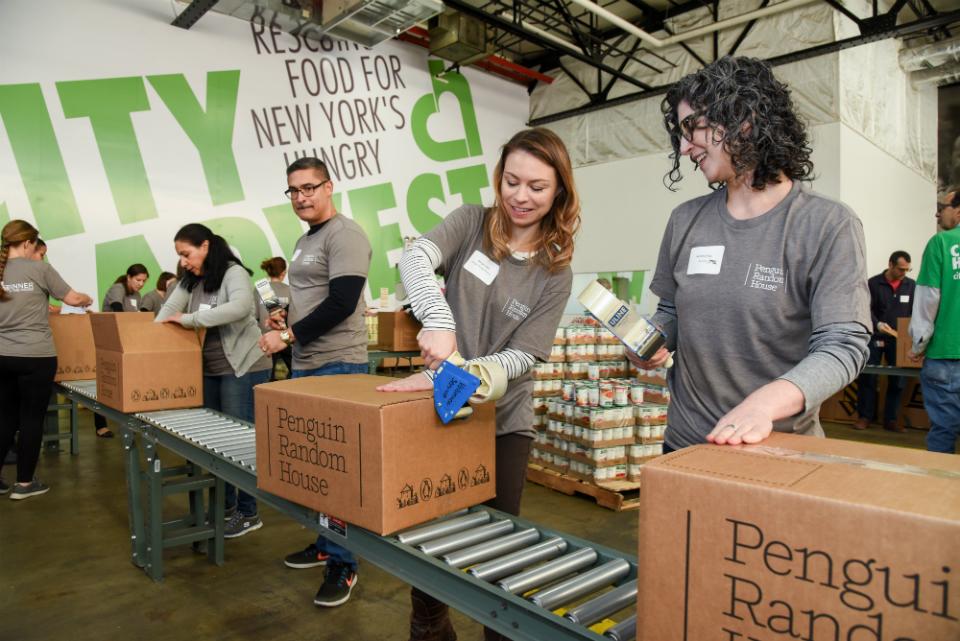 PRH employees pack boxes with holiday meals for hungry New Yorkers at our 2017 Dinner on the House event at City Harvest's food rescue facility.