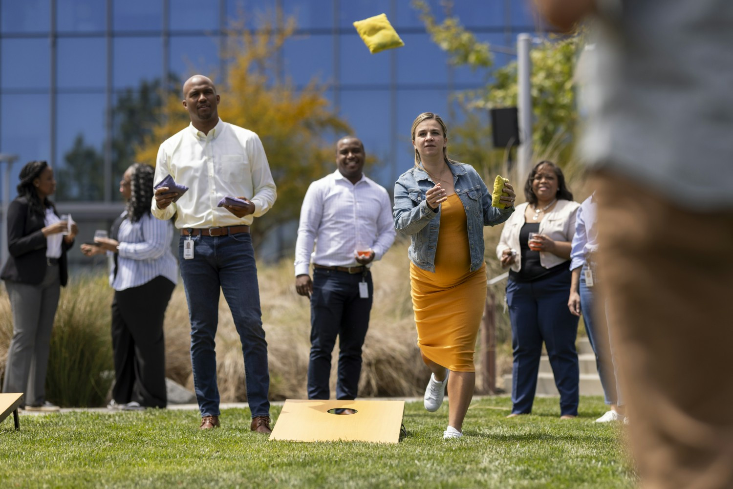 Vertexians playing corn hole at a celebration at our San Diego site