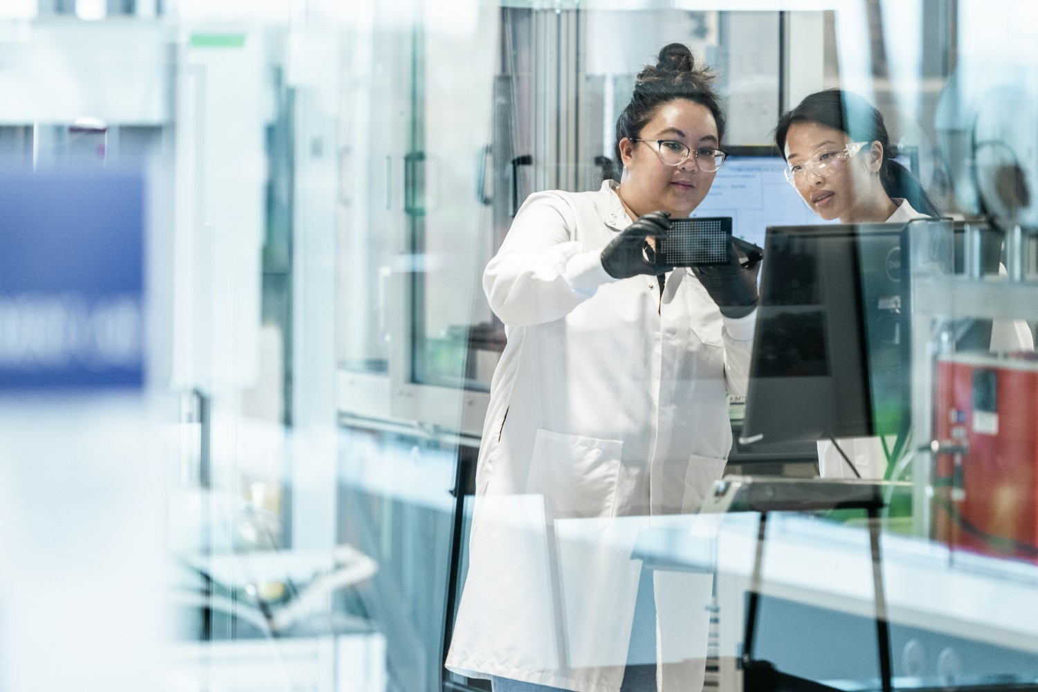 Two researchers discussing our transformative science in the lab