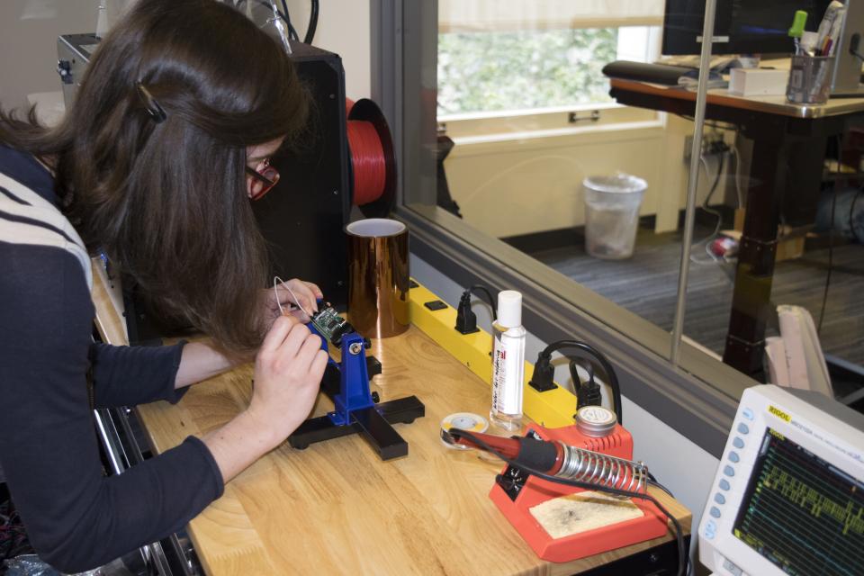 Senior Engineer Meghane wiring up a board