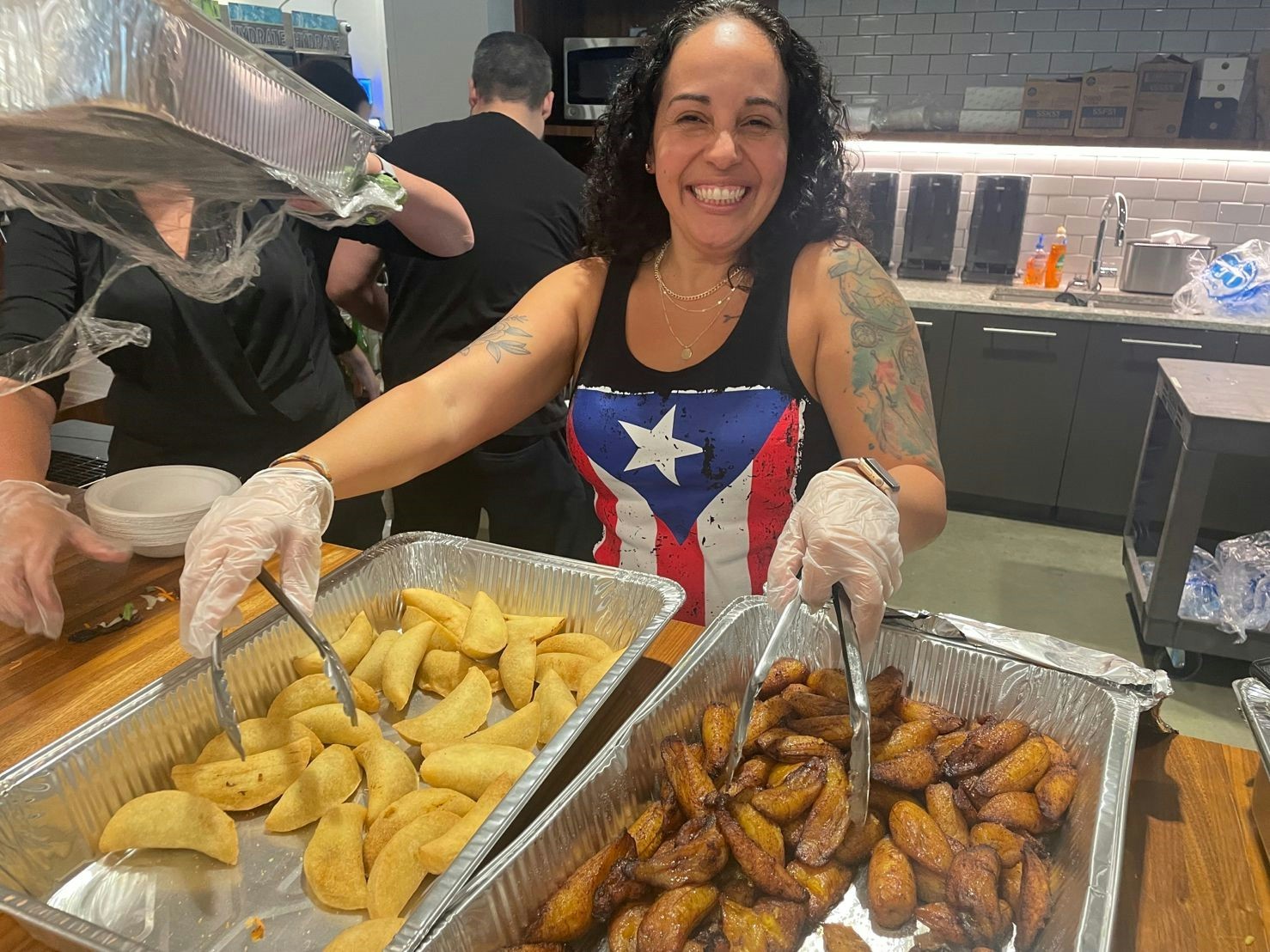 A member of the LatinXers serves traditional latin food at the annual LatinXers Festival. 