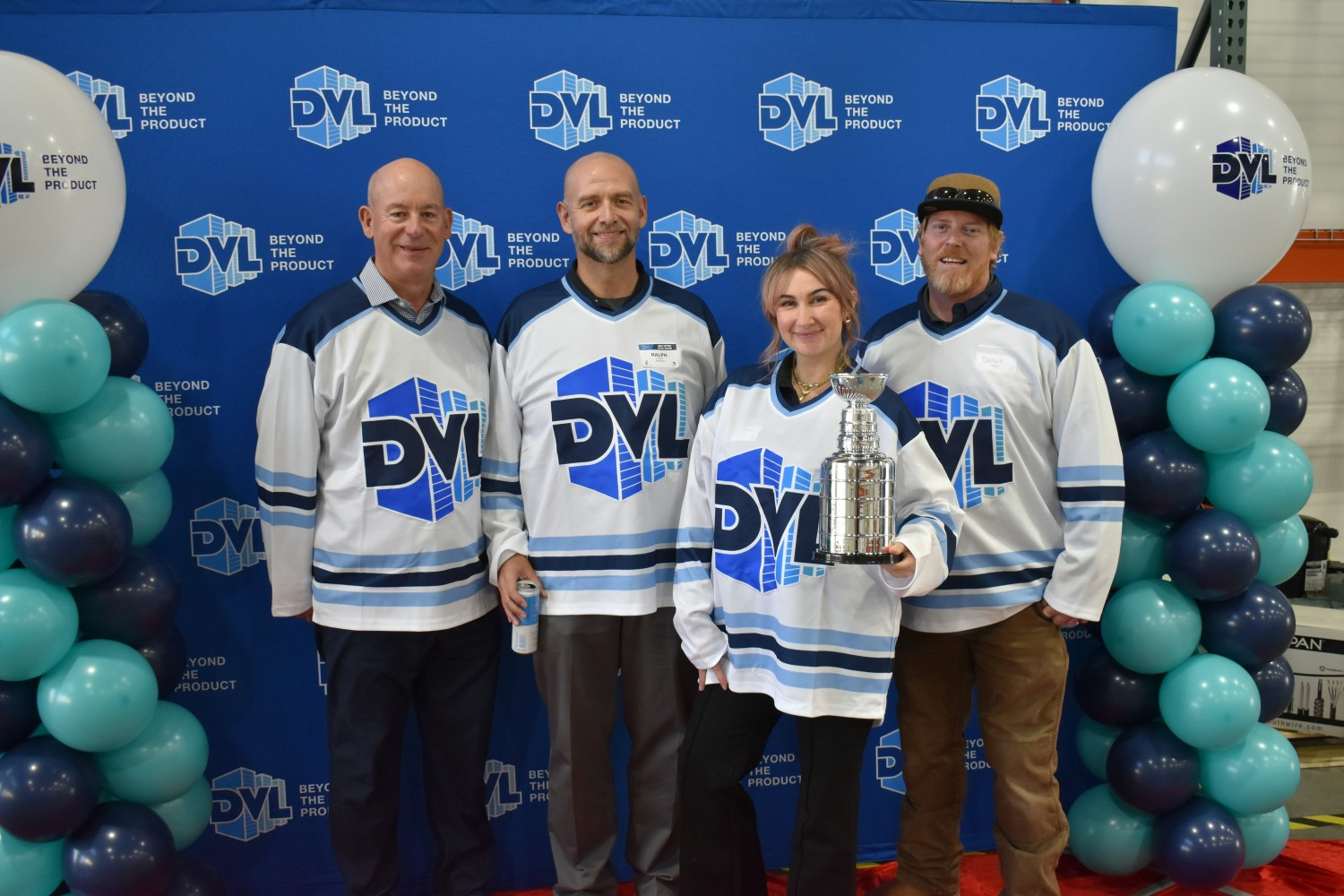 After outgrowing a smaller space, associates celebrate the new office at a hockey-themed open house for customers.