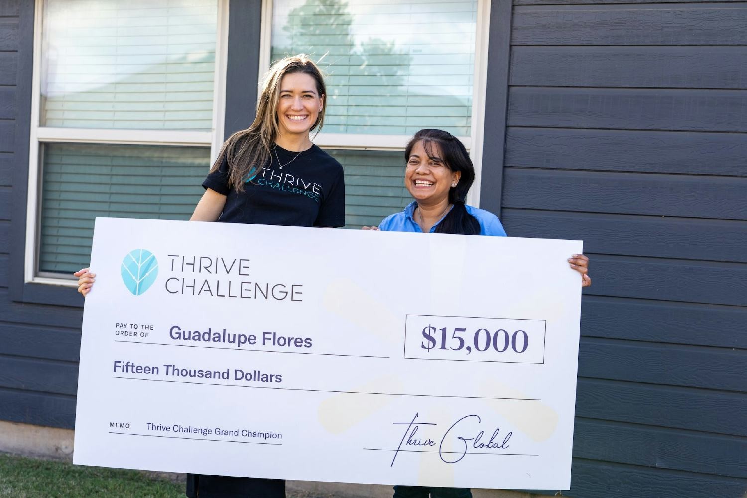 Thrive's SVP of Customer Success MT Grant presents a prize to a Thrive Challenge Grand Champion.