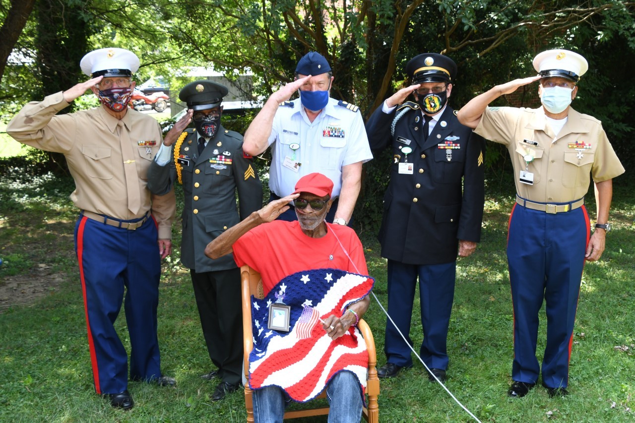 Gilchrist's We Honor Veterans team honors a veteran patient with a salute to service ceremony. 