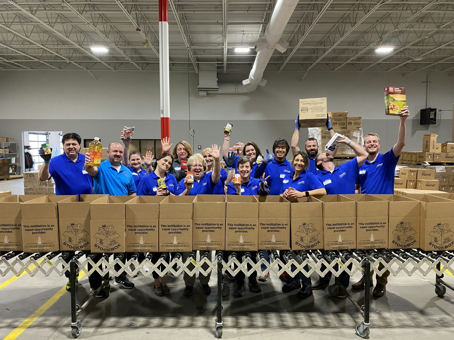 Our Senior Leadership team volunteering at Hunger Task Force to make senior stock boxes