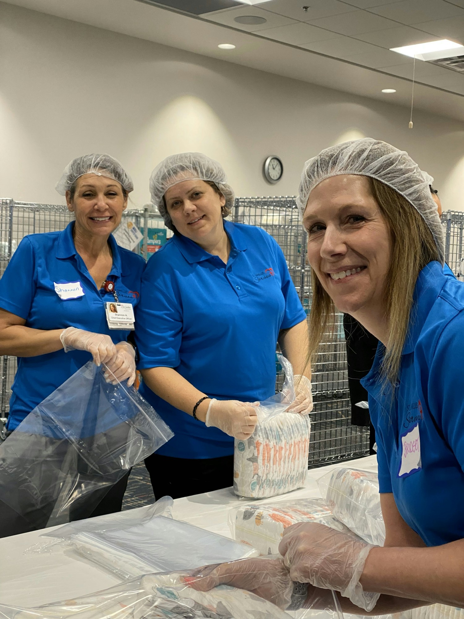 Staff volunteering to sort diapers at the United Way