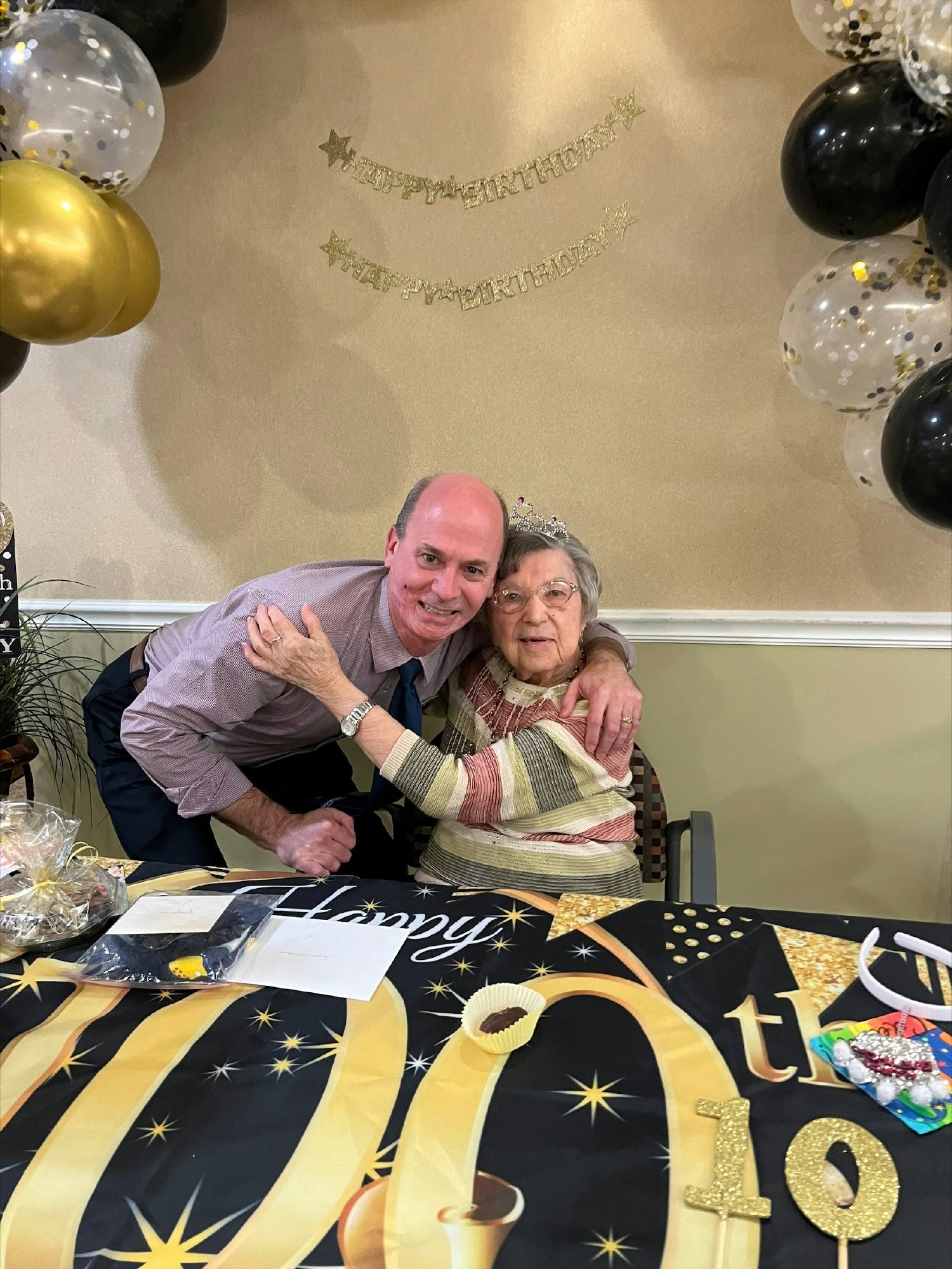 CEO Roger Ellens celebrating with a resident at their 100th birthday!