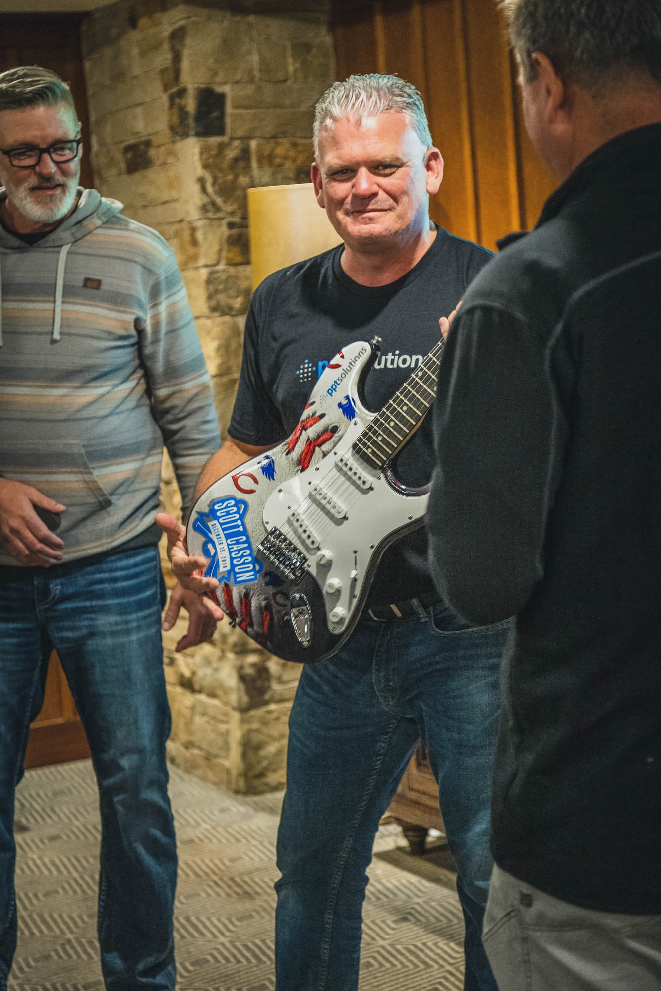 SVP of Delivery receives recognition (personalized guitar) for excellent individual and team performance
