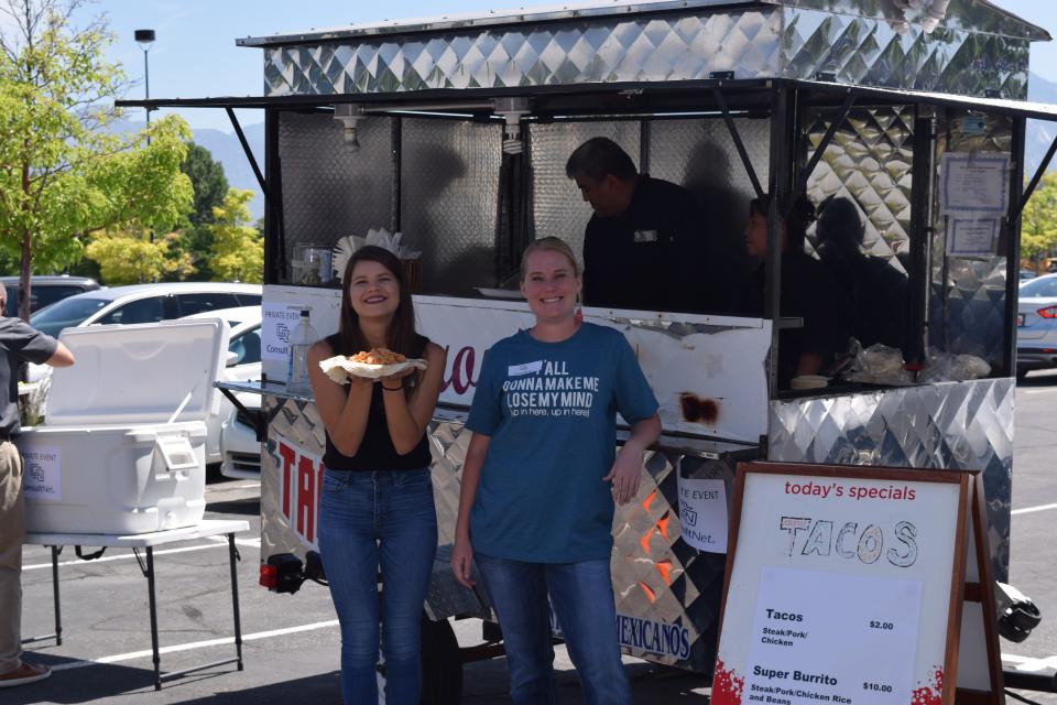 Some of our team members enjoying the taco stand at our summer season party