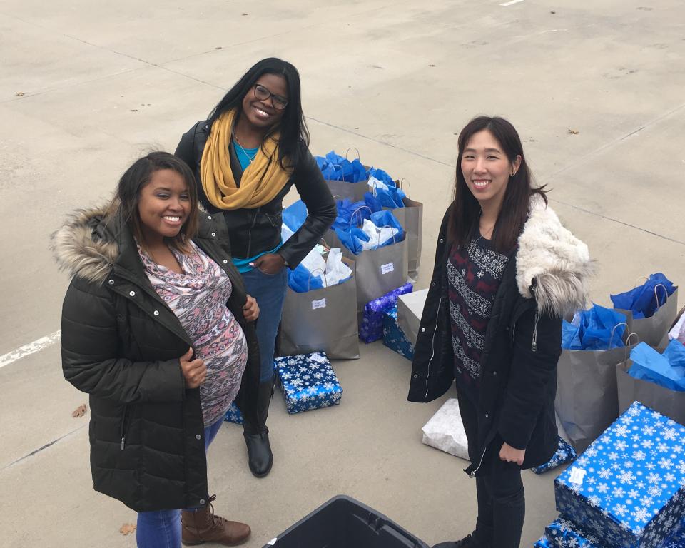 Volunteers delivering gifts for the Frisco Family Services Silver Bells Holiday Party.