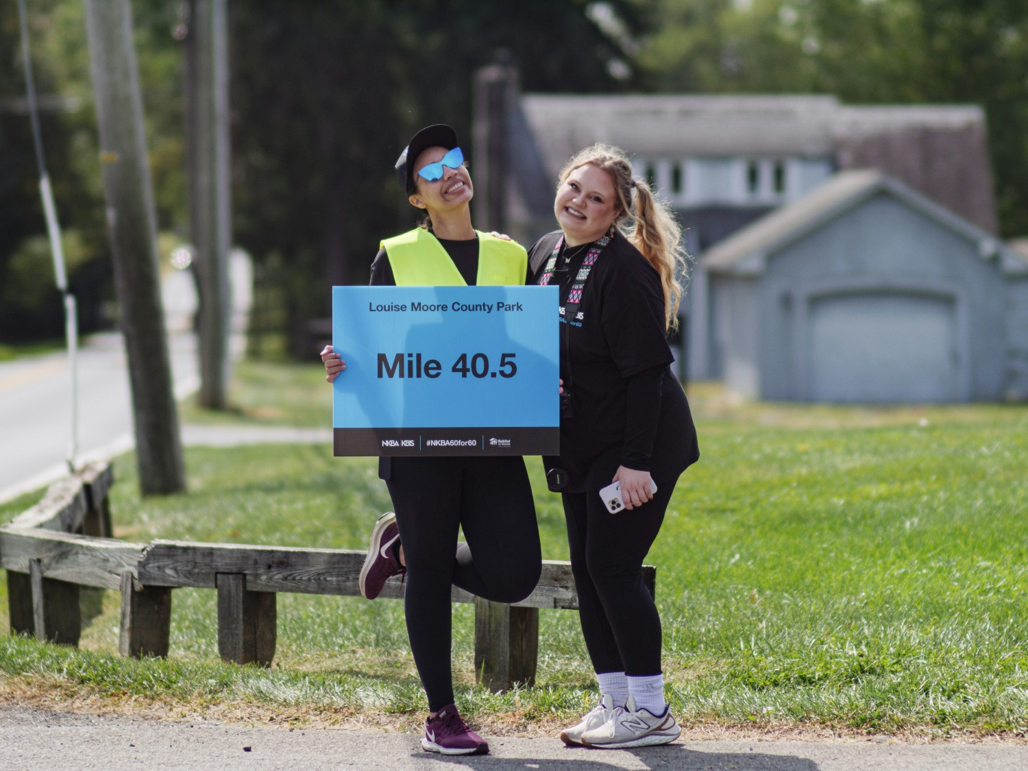 A picture of two staff members who volunteered to guide the bike riders during the 60to60 NKBA Anniversary event.
