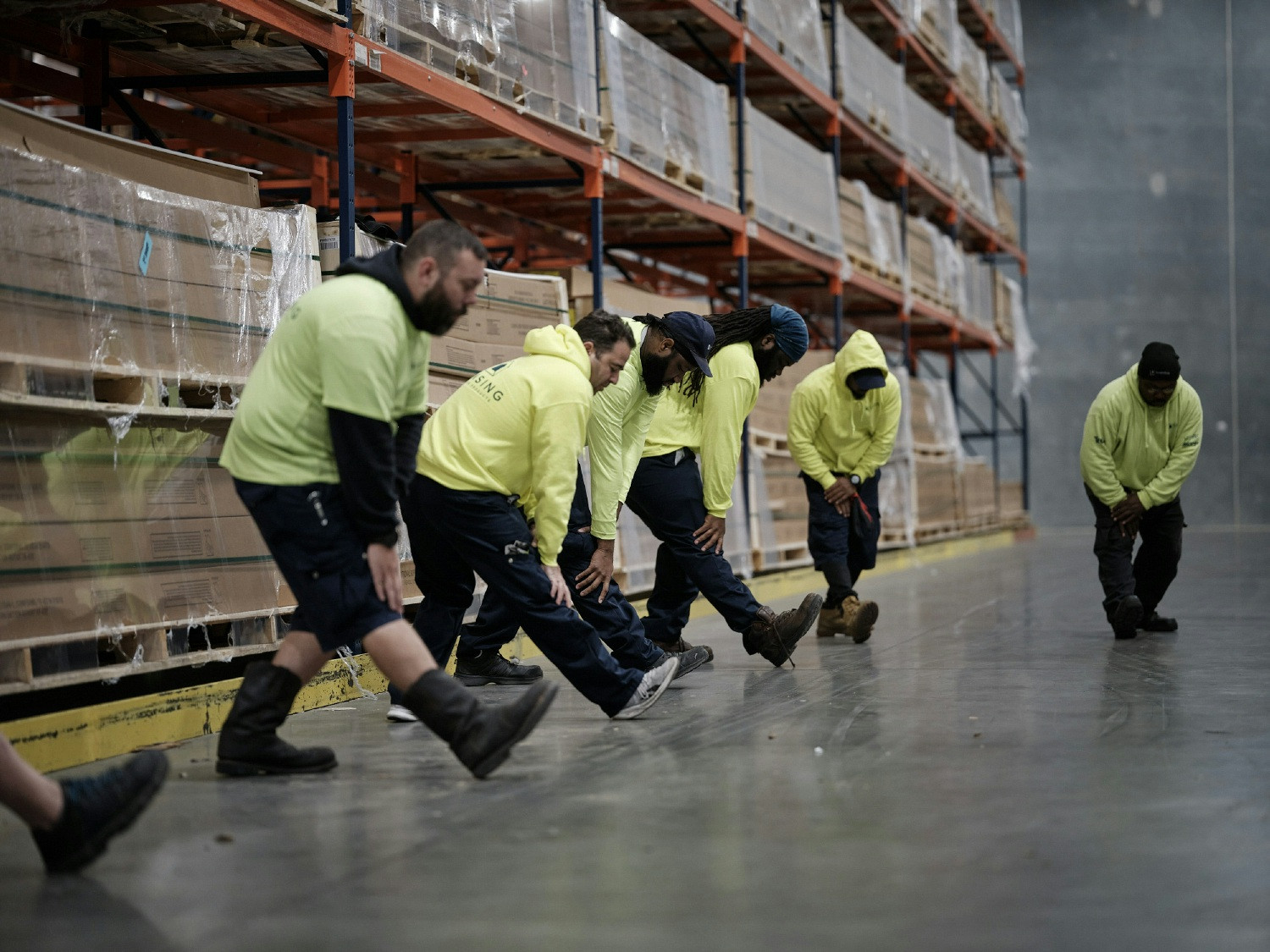 Warehouse associates in Raleigh participate in morning stretches. 