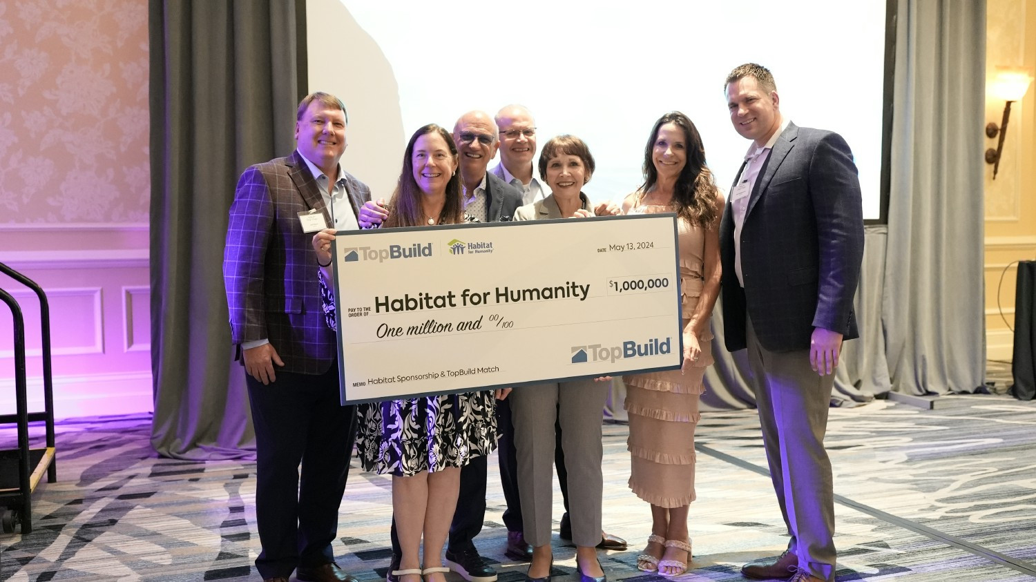 TopBuild Leadership present the donation check to Habitat for Humanity 