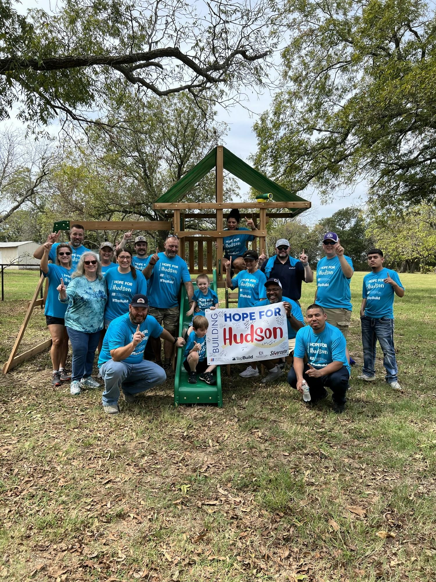 Group of employees that built a playset for a pediatric cancer patient in Houston (Nascar Foundation)