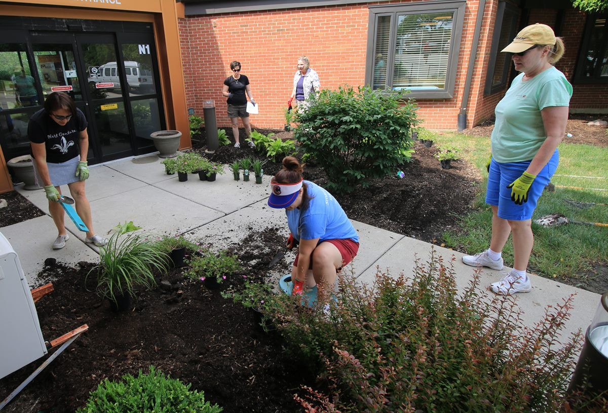 Ball employees volunteering at a local nursing home by planting there gardens