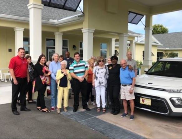 Residents & Team Members celebrating our Benton House employee who was one of two who won the company-wide car raffle!