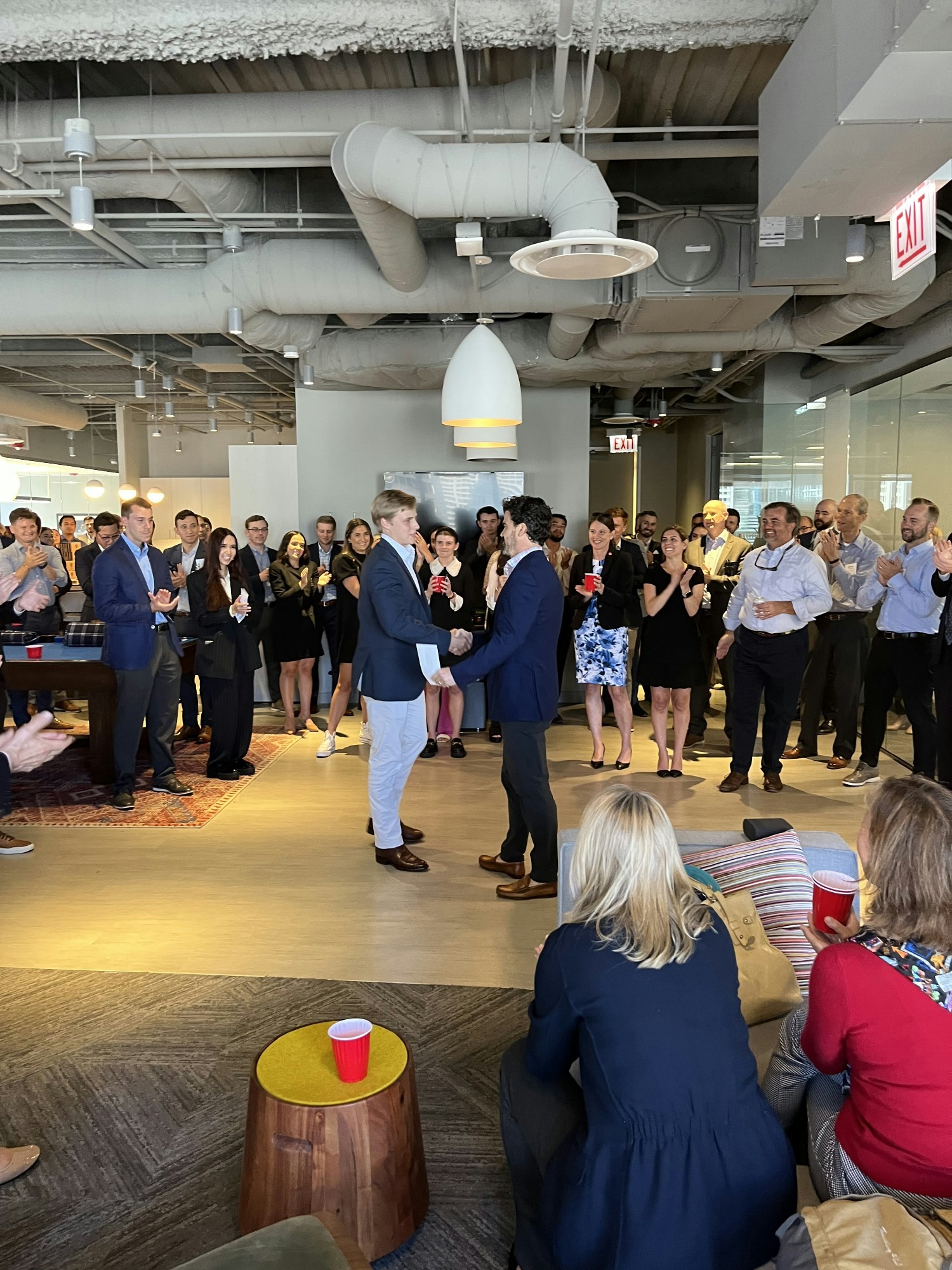 Employees gathered as internship awards are announced.