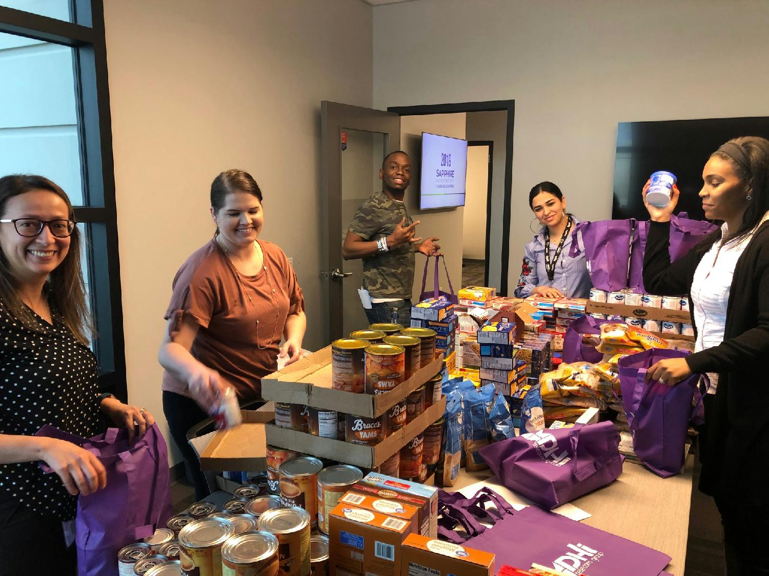 DHI Employees packing up Thanksgiving Meal Box donations for Reynold's Elementary School.