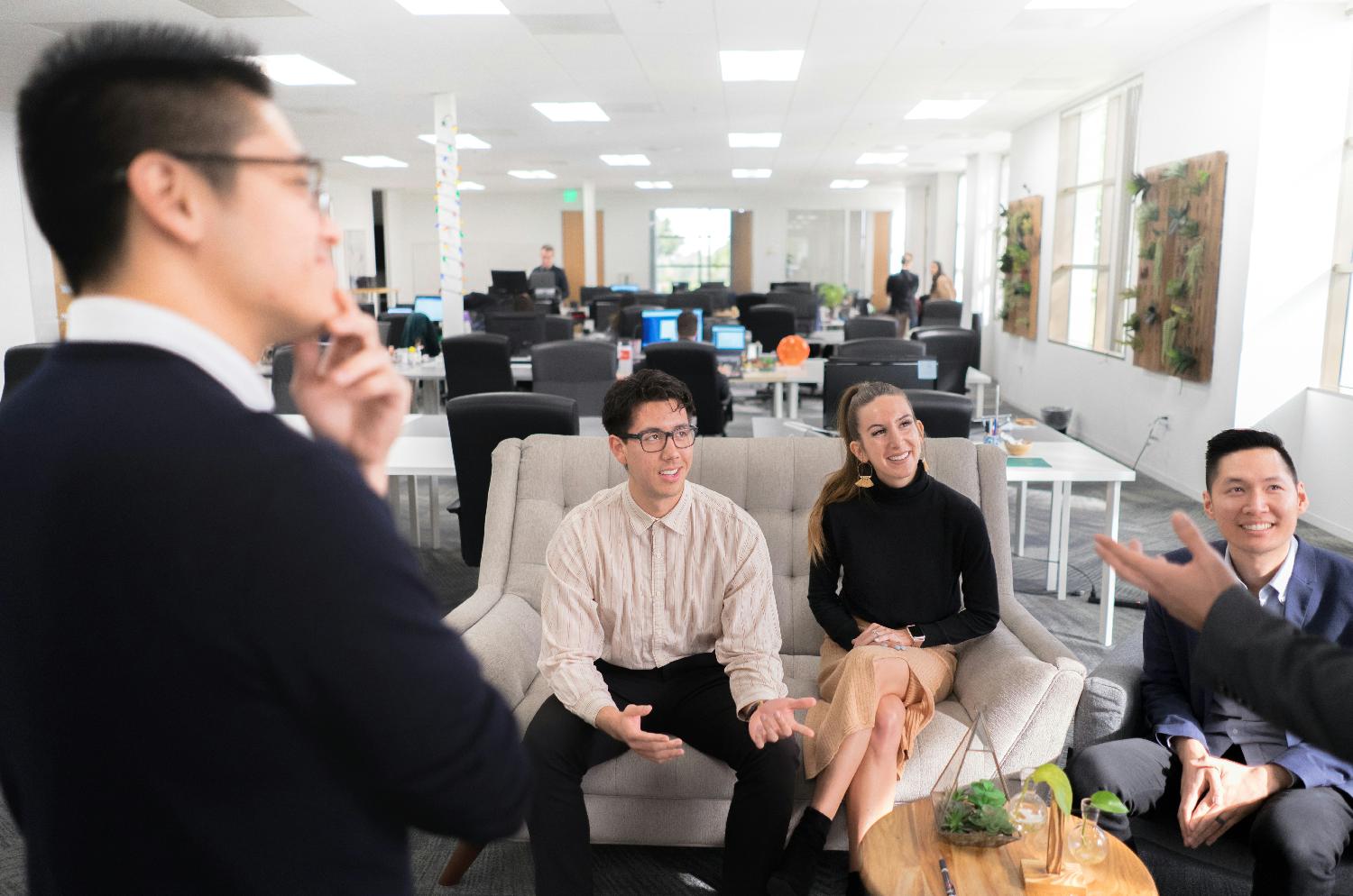 Four of Directive's teammates chatting in the Irvine, California office. 