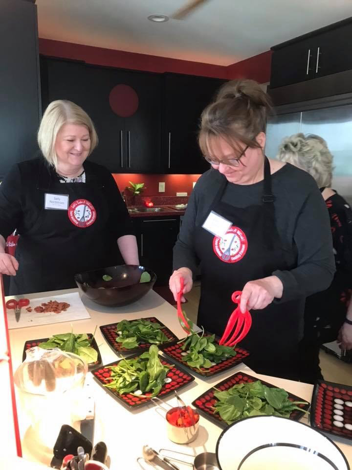 Sally and Shannon prepare a meal together in a team building exercise.